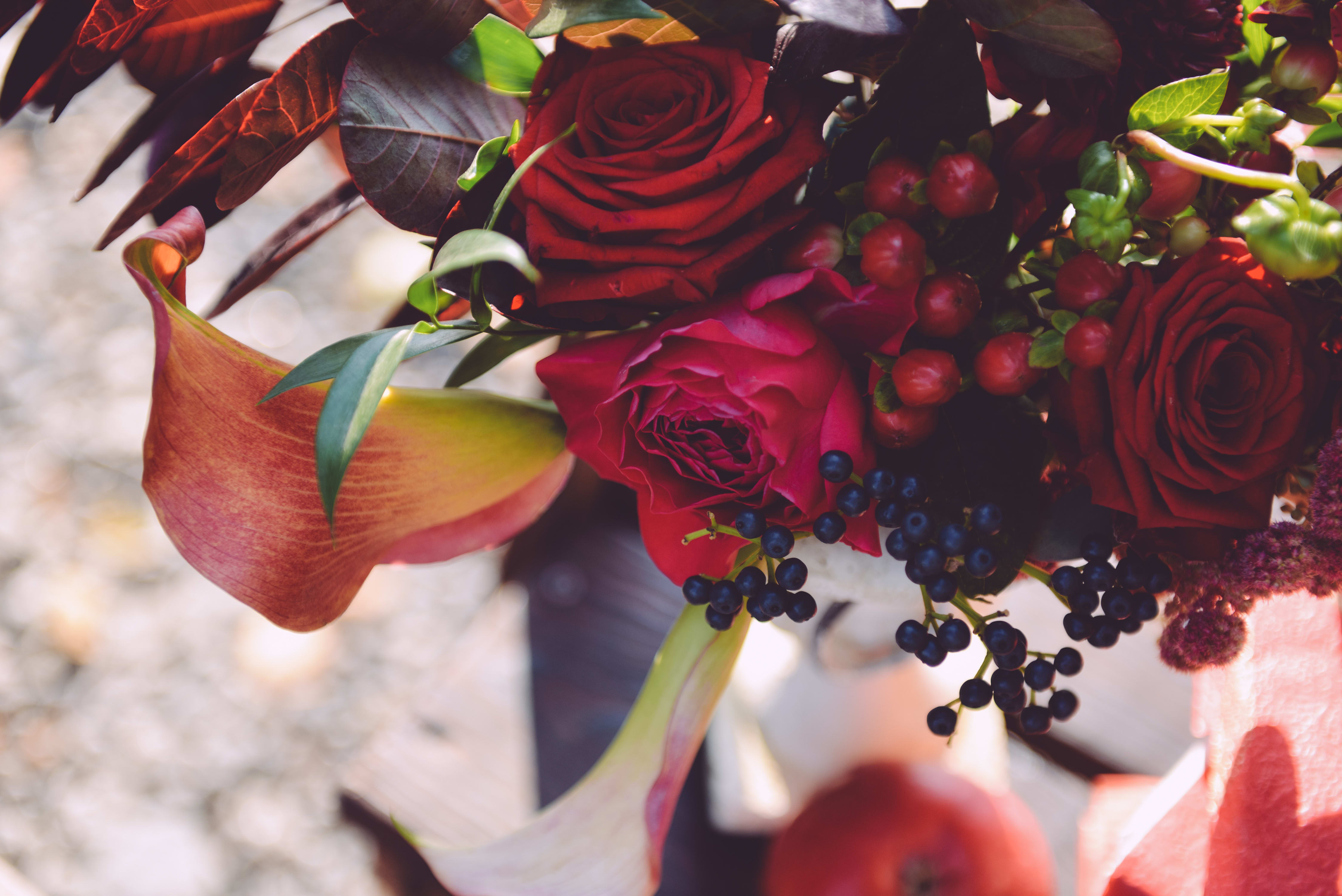 Designer's Choice - Modern Romance - Floral arrangement in romantic hues (i.e. red, burgundy, green, silver, gold, blue, white, cream, peach, etc.) presented in a clear glass or ceramic vessel. Includes red roses.  Each Designer's Choice vase arrangement will be one of a kind and consist of fresh, seasonal flowers. The arrangement depicted in the photo is just one example of our Designer's Choice Vase Arrangement. Actual arrangement may vary in terms of flower type, color scheme, and overall design depending on seasonal and local availability - but will be similar in size and include flowers of equal value.  Standard - 6&quot; x 6&quot; Vase Deluxe - 6.5&quot; x 6.5&quot; Vase Premium - 7&quot;x 7&quot; Vase