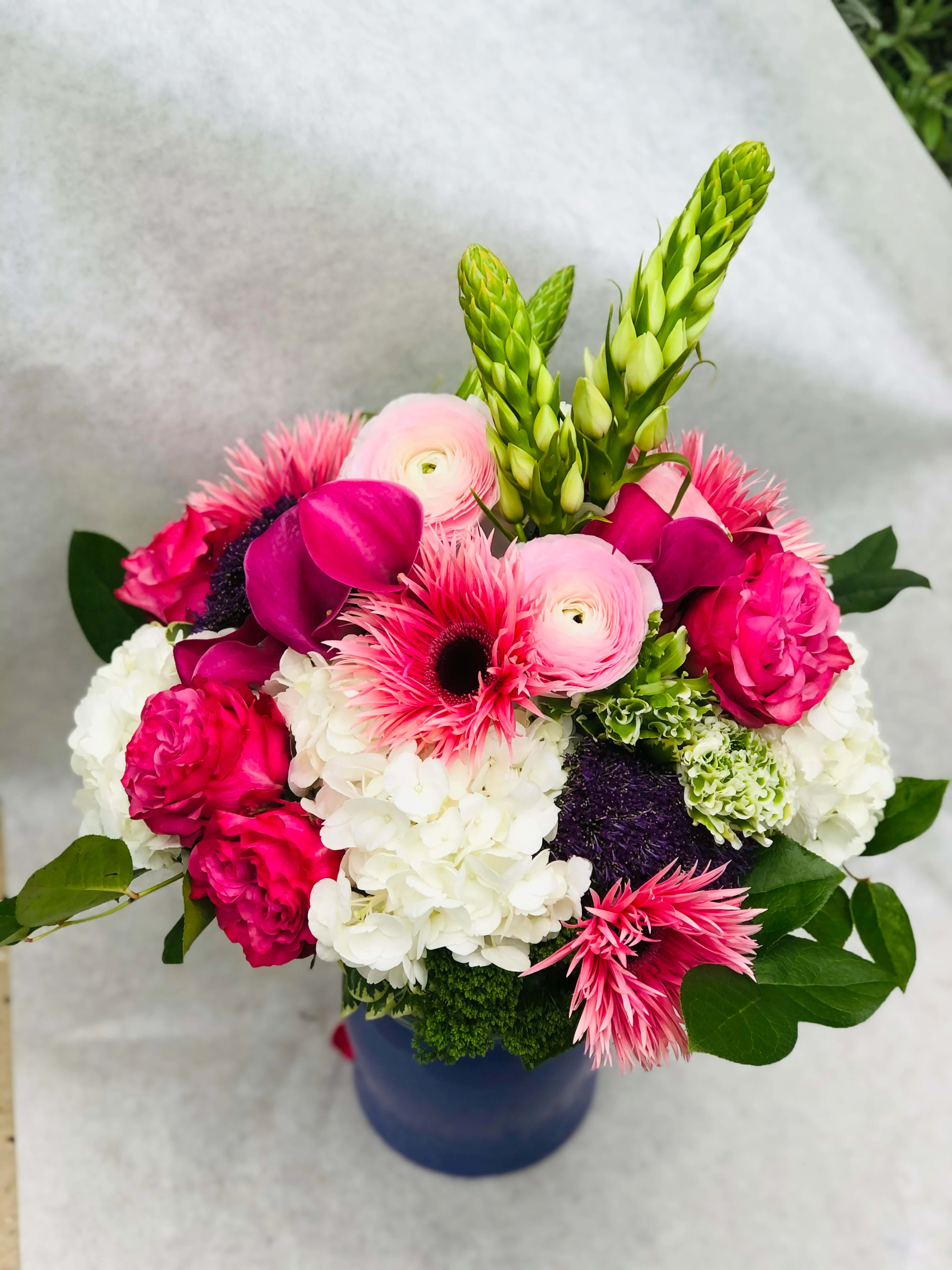 Julia - This stunning color display of Hydragea, Gerbera Daisies, Roses, calls lullies and so much more will be sure to express the Love we have for all the Moms we celebrate! 