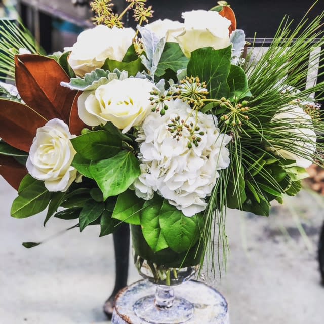 Tara's Winter Garden - A mixture of Seasonal Greens with stunning White Hydrangea, White Roses, Magnolia, Tree Ivy and seeded Eucalyptus in classic glass vase  