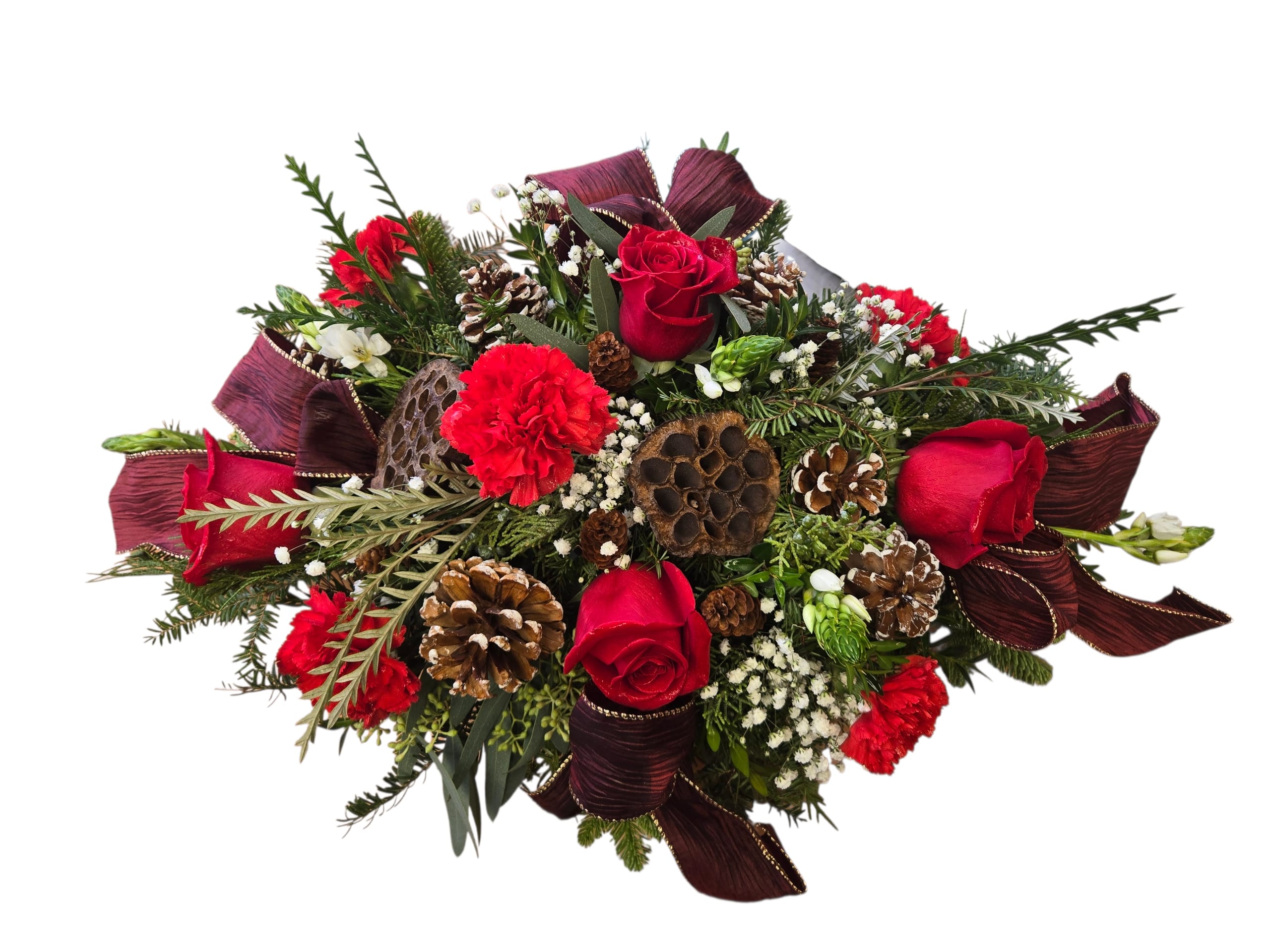 Winter Crimson Elegance - Winter Crimson Elegance Bring the warmth and magic of the season to your table with this stunning holiday centerpiece. Designed with rich red roses, vibrant carnations, winter greens, and snowy-tipped pinecones, it captures all the depth and texture of a classic winter celebration. Lotus pods and lush seasonal foliage add natural charm, while deep burgundy accents create a luxurious, festive finish. Perfect for holiday gatherings, gifting, or elevating your home décor with timeless seasonal beauty.