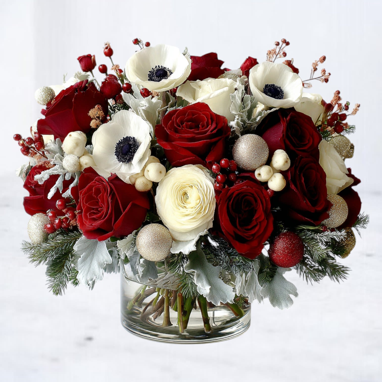 Crimson Chalet - Crimson Chalet is where chalet-style winter charm meets luxury holiday florals. Designed with rich red roses, premium white ranunculus, snowy hydrangea, and striking anemones, this arrangement layers winter greenery, frosted accents, and sparkling ornament touches for a look that feels romantic, festive, and unmistakably high-end.  Perfect for holiday tables, upscale gatherings, December birthdays, or as a statement gift, this lush design brings warmth and elegance to any home—whether you're hosting a cozy fireside dinner or decorating a modern winter retreat.  Now available for same-day holiday flower delivery in Galveston, Jamaica Beach, Tiki Island, Sea Isle, Hitchcock, La Marque, Santa Fe, Texas City, League City, Dickinson, Kemah, Clear Lake, Webster, and surrounding coastal communities along Galveston Bay.  Substitution Disclaimer Due to seasonal availability, some blooms or accents may be replaced with similar premium varieties of equal or greater value to maintain the design’s look and integrity. Your arrangement will always reflect the same spirit, palette, and premium quality.