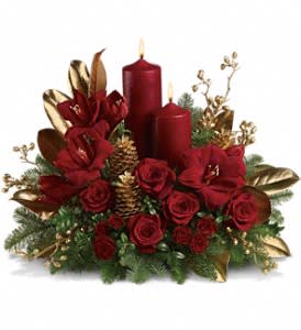 Candlelit Christmas - Christmas by candlelight is the perfect way to delight in the warmth and joy of the season. This elegant arrangement will be at home anywhere in the house, adding grace and beauty to any holiday celebration.  Ruby red amaryllis, roses and spray roses are perfectly arranged with golden pinecones and holiday greenery. Two pillar candles in a stunning shade of pomegranate are the perfect touch to light up the night.  Approximately 23" W x 18" H  Orientation: All-Around  As Shown : T113-1A Deluxe : T113-1B Premium : T113-1C