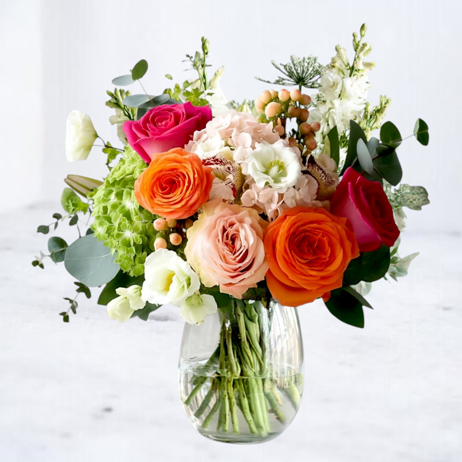 Kaleidos - Like a kaleidoscope of shifting colors, Kaleidos brings together bold and soft tones in one unforgettable arrangement. Featuring vibrant orange and fuchsia roses, soft blush blooms, hydrangea, and delicate accents, this design feels modern, artistic, and full of life. Perfect for birthdays, anniversaries, congratulations, or simply to brighten someone’s day, it’s an arrangement that adapts to any occasion.  Available for same-day flower delivery in Magnolia, The Woodlands, Spring, Conroe, Tomball, Cypress, and the Greater Houston area, this bouquet is a versatile choice when you want to send something unforgettable.