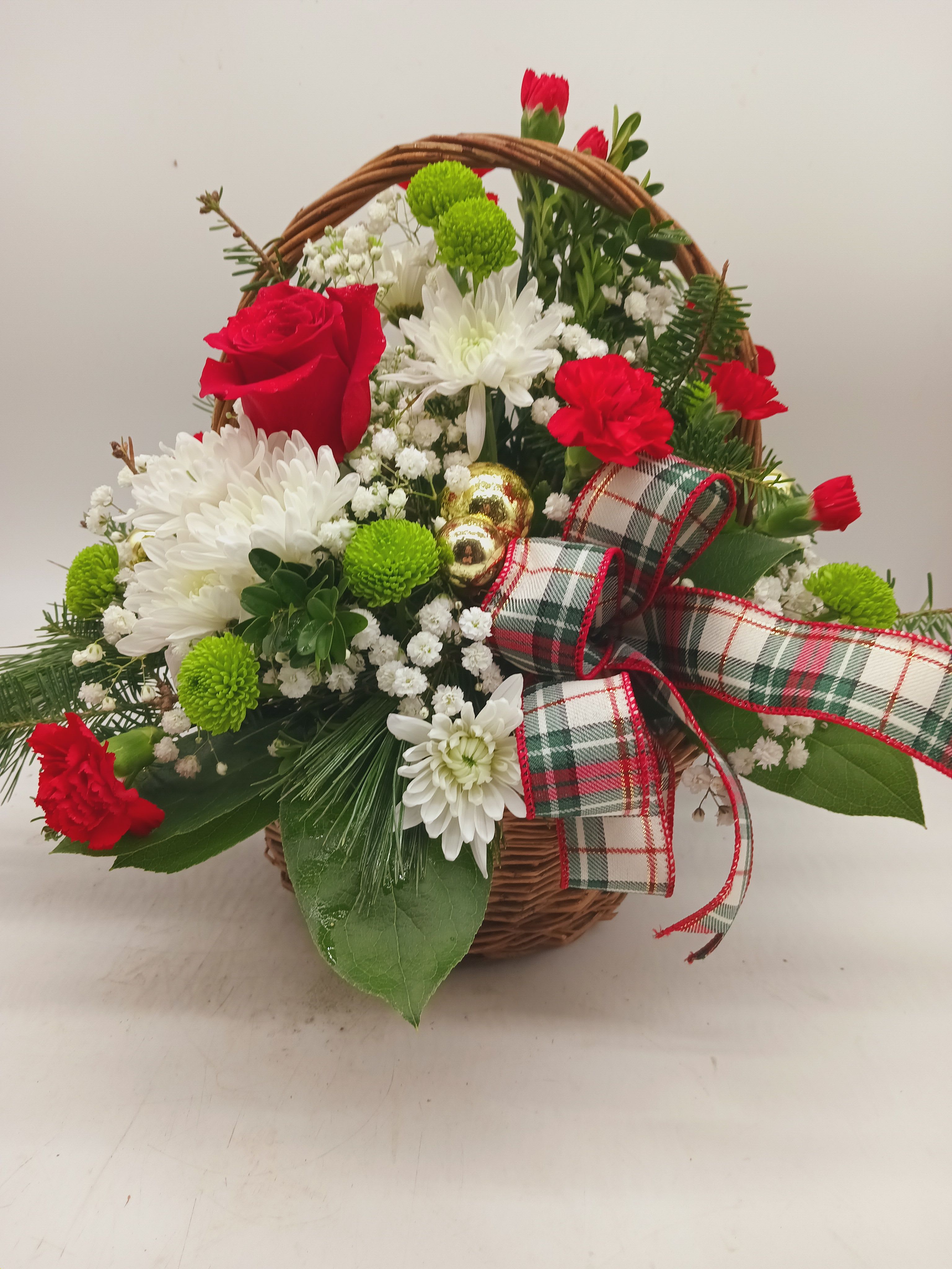 The Basket of Cheer  - A basket full of Cheer! Full of seasonal favorites, the basket is adorned with reds, whites, and greens; all staples of the Holiday Season! Comes with ceramic ornament as a keepsake