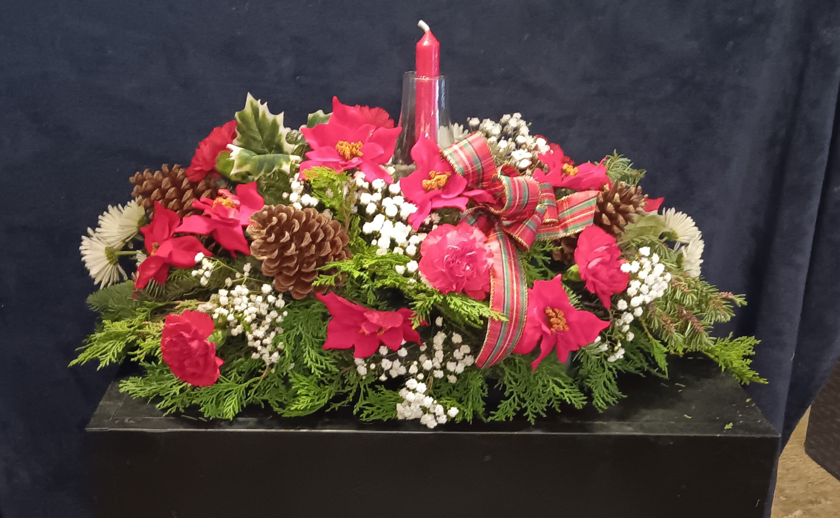 Christmas centerpiece  - Mixed floral Arrangement with candle accented by fragrant greens and and pine cones 
