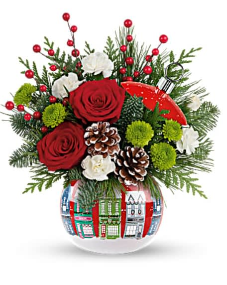 Teleflora's Silent Night Bouquet - Capture the wonder of a silent, snowy night with this beautiful holiday gift! The ceramic ornament jar is adorned with a quaint Christmas village and bursts with a spirited holiday bouquet. Red roses, miniature white carnations and green button spray chrysanthemums are accented with noble fir, cedar and white pine. Delivered in Teleflora's Snowy Village Ornament. Orientation: All-Around