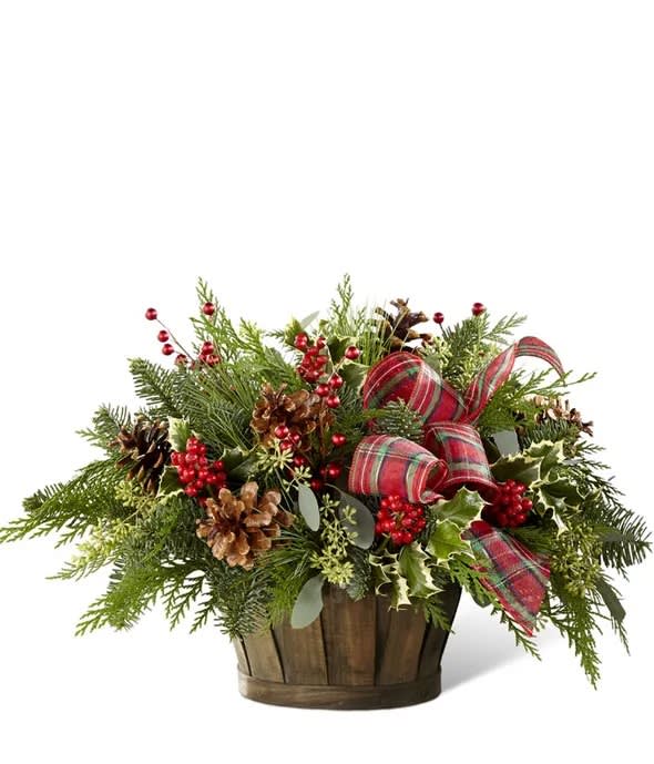 Home for the Holiday Basket - Feel like you're celebrating the holidays in a rustic farmhouse as you admire this basket full of assorted Christmas greens arranged in a dark wooden basket. This arrangement will spruce up your home and make it picture perfect for Christmas. Approximate Size: 13"H x 20"W.