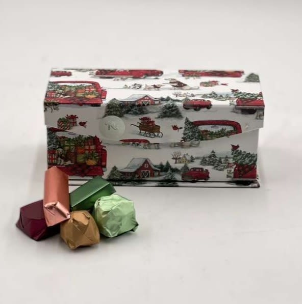 Holiday Village Chocolate Box - A festive holiday chocolate box wrapped in charming winter village artwork, filled with an assortment of premium chocolates in colorful seasonal foils. The box opens to reveal a cozy green plaid interior, adding a warm holiday touch. Perfect as a festive gift, a hostess present, or a sweet addition to any Christmas celebration. 