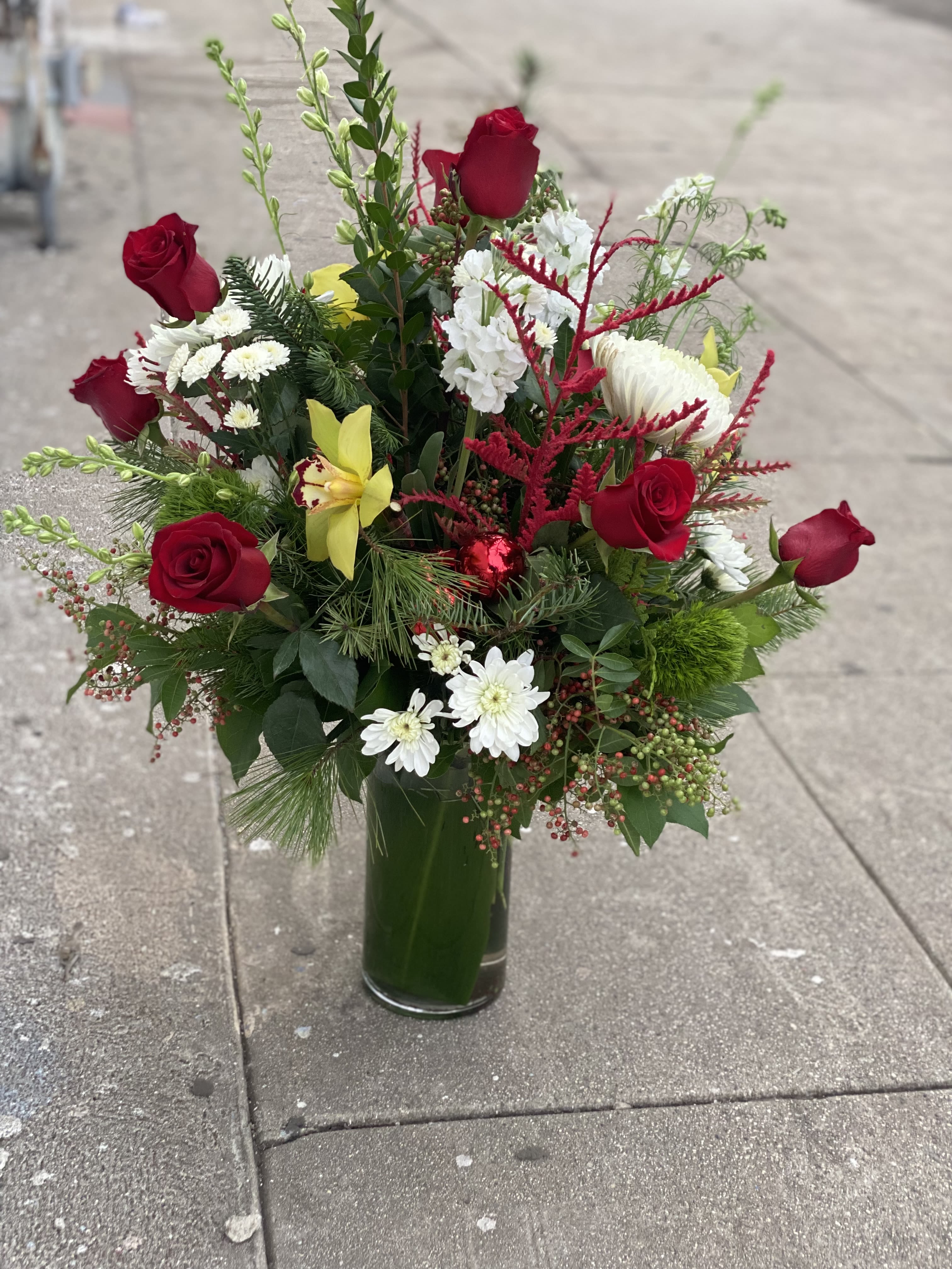 Navidad! - Spread holiday cheer, with this arrangement of roses, orchid cymbidium, mix fir and much more 