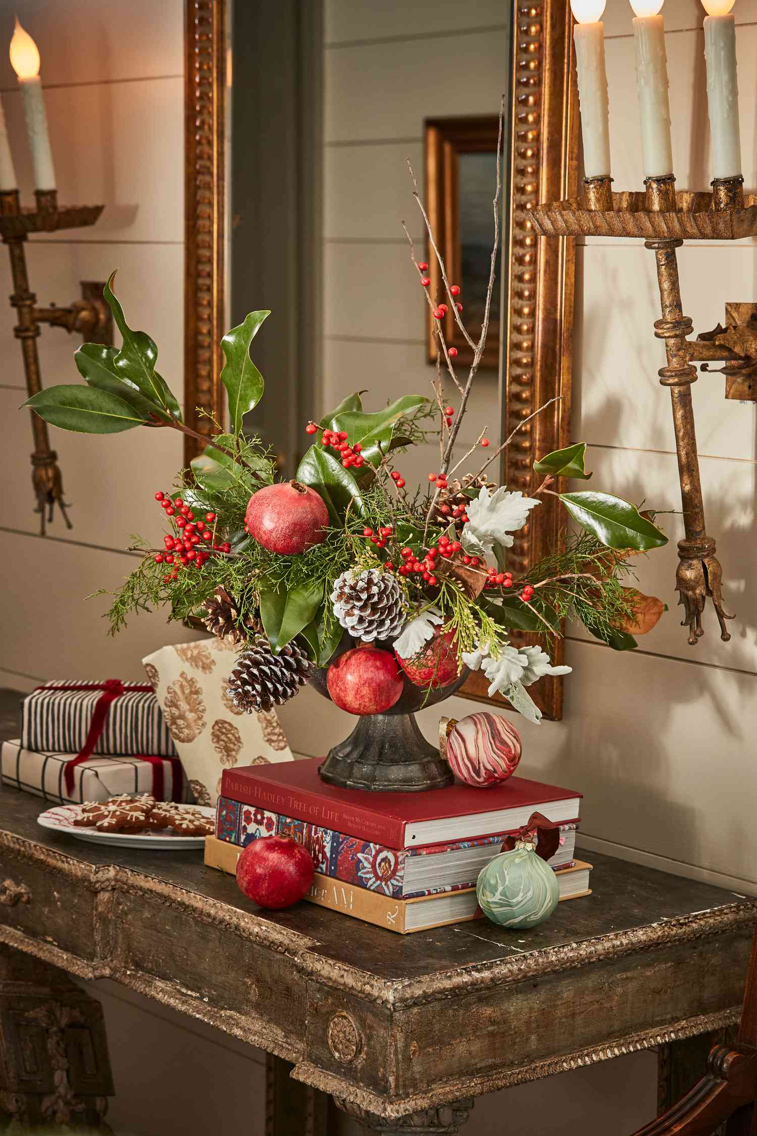 Christmas Centerpiece - Christmas centerpiece with winter greens and decorations placed inside a decorative gold metal container