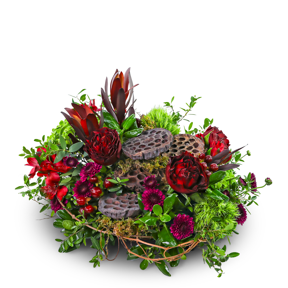 Rosewood Embrace - Rosewood Embrace is a rich mix of deep red roses, burgundy blooms, vibrant greenery, and unique lotus pods that add a natural touch. Designed low and wrapped in willow vines, it makes a beautiful centerpiece for your home or event. Our local florist may make a few thoughtful substitutions to ensure fresh, on-time flower delivery while keeping the same warm, earthy vibe.