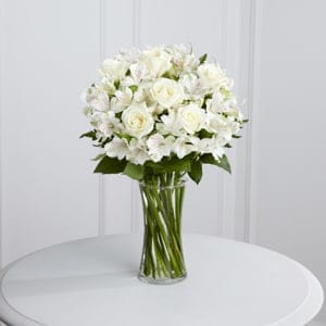 The FTD® Cherished Friend Bouquet - The FTD® Cherished Friend™ Bouquet offers comfort and sympathy in the time of grief and loss. Bright white roses and Peruvian lilies are accented by lush greens and gorgeously arranged in a clear glass gathering vase to create a bouquet that will bring peace and show how much you care.