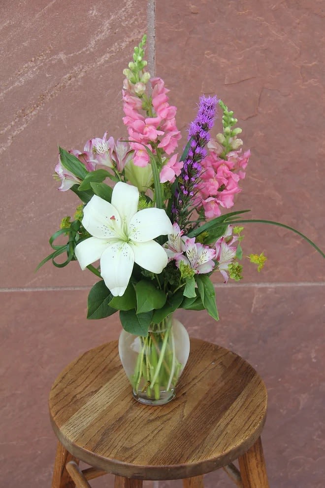 Everyday #3 - A medium sized arrangement with a white lily and other filler.