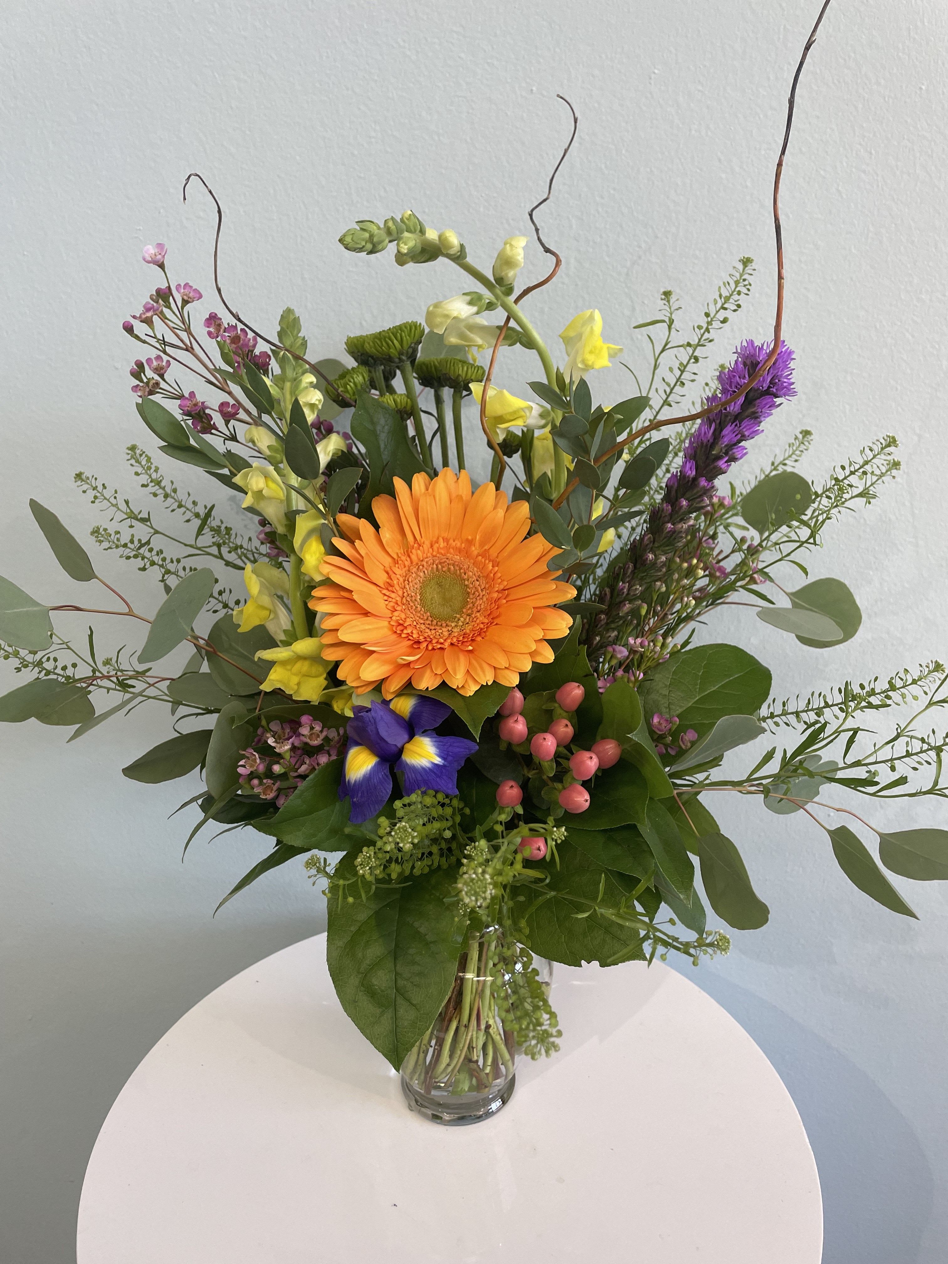 Over The Rainbow - This colorful arrangement is the perfect gift for any occasion. Inspired by the many colors of the rainbow, this small yet eye catching arrangement may include a gerbera daisy, snap dragons, and a colorful assortment of bright flowers sure to brighten anyone's day! 