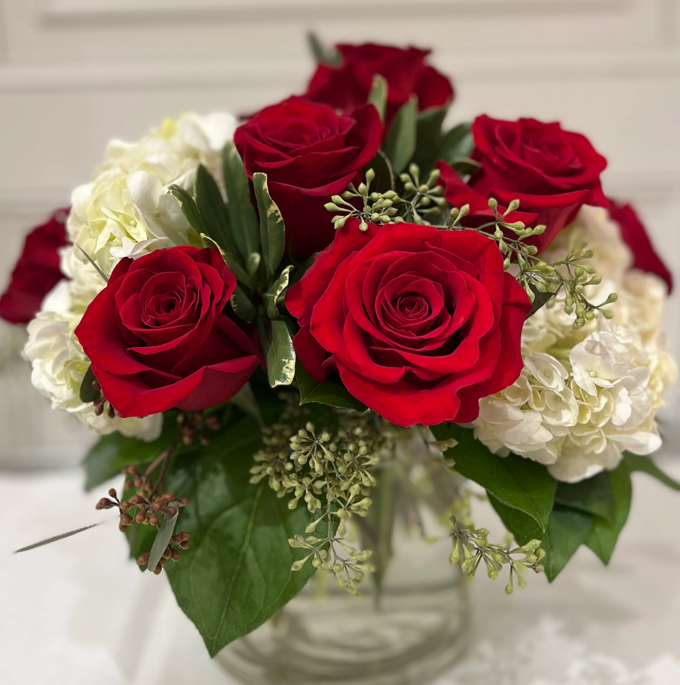 &quot;Romantic Intentions&quot; Bouquet - Stunning red roses are paired with white hydrangea and a mixture of greenery. Designed in a low and lush fashion, it's easy to enjoy! Please let us know if you would like a different color other than red, we are happy to accommodate your request.