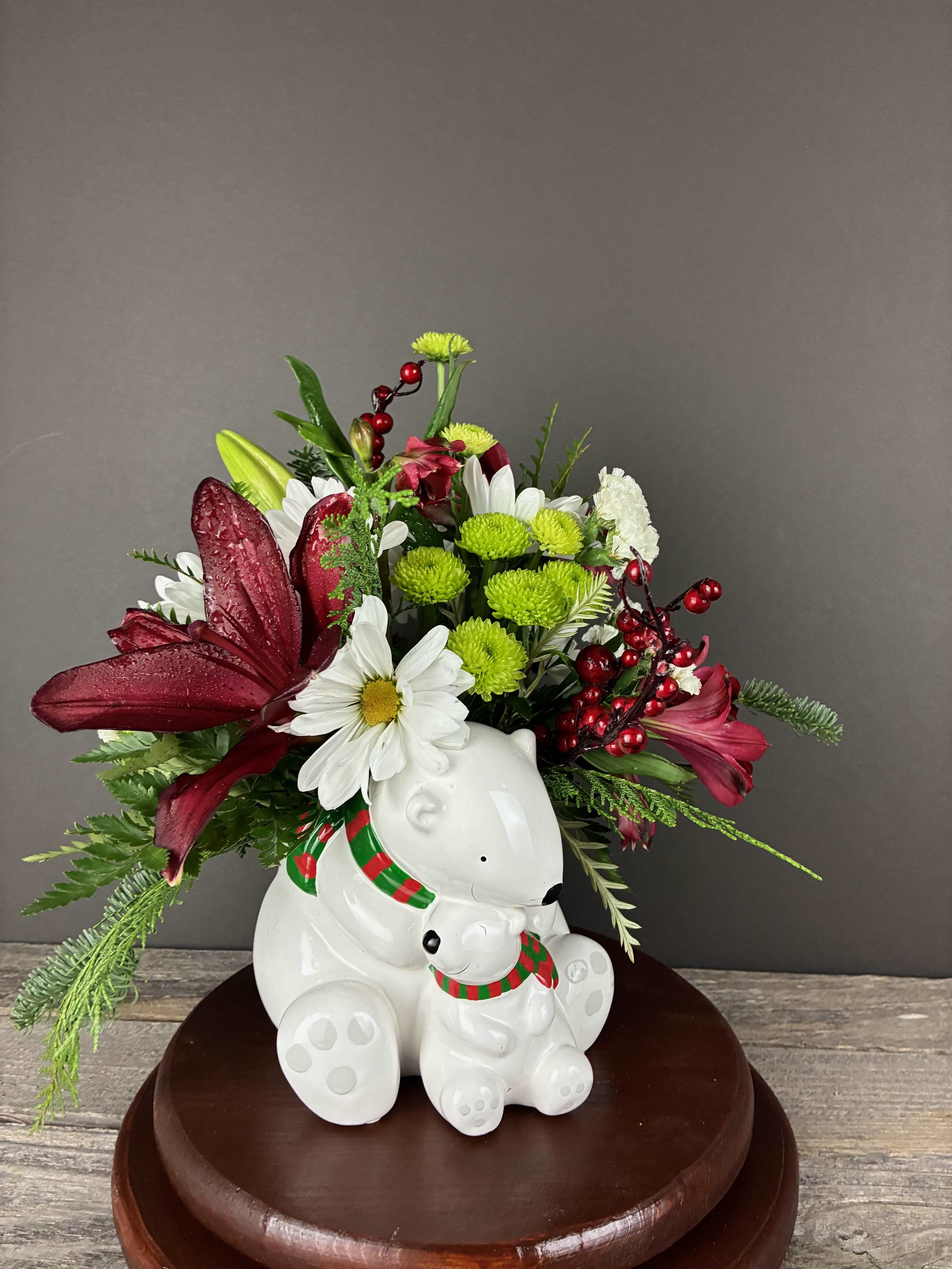 Polar Bear Peace - This adorable polar bear container with red lilies, green button mums, and cedar is sure to brighten anyone's day!