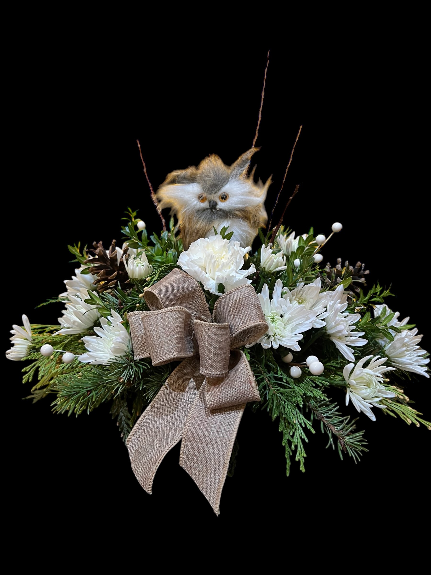 Whoo's ready for the Holidays... - Centerpiece of mixed winter greens, white mums and berries, natural cones and twigs, burlap ribbons, and 2 adorable, fluffy owls. Our own design - limited number available.