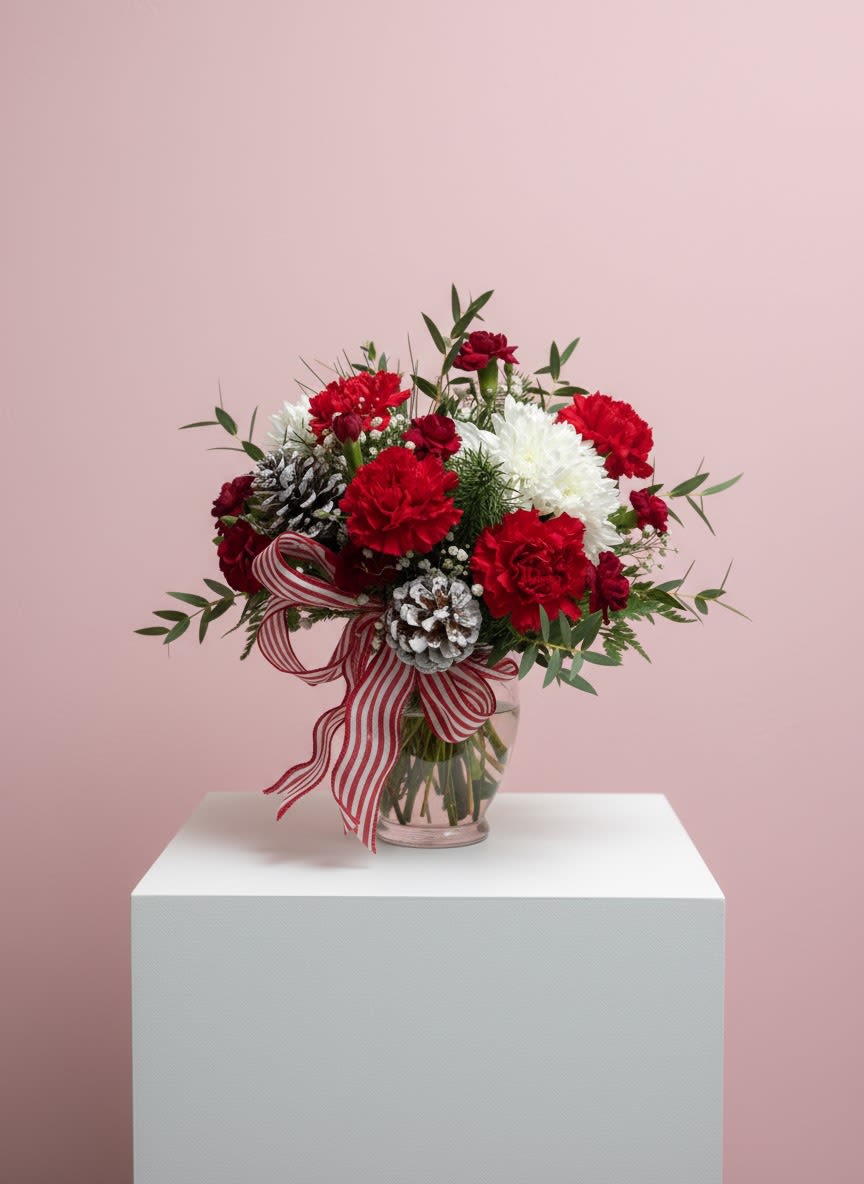 Jolly &amp; Bright Bouquet - A festive one-sided mix of red and white blooms, frosted pinecones, winter greens, and a fun peppermint ribbon. Perfect for adding a pop of holiday cheer.