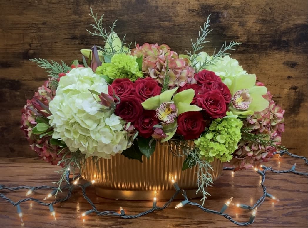 Holiday Table - Elegant centerpiece arrangement  with spray roses, assorted hydrangeas, cymbidium orchid heads, winter greenery