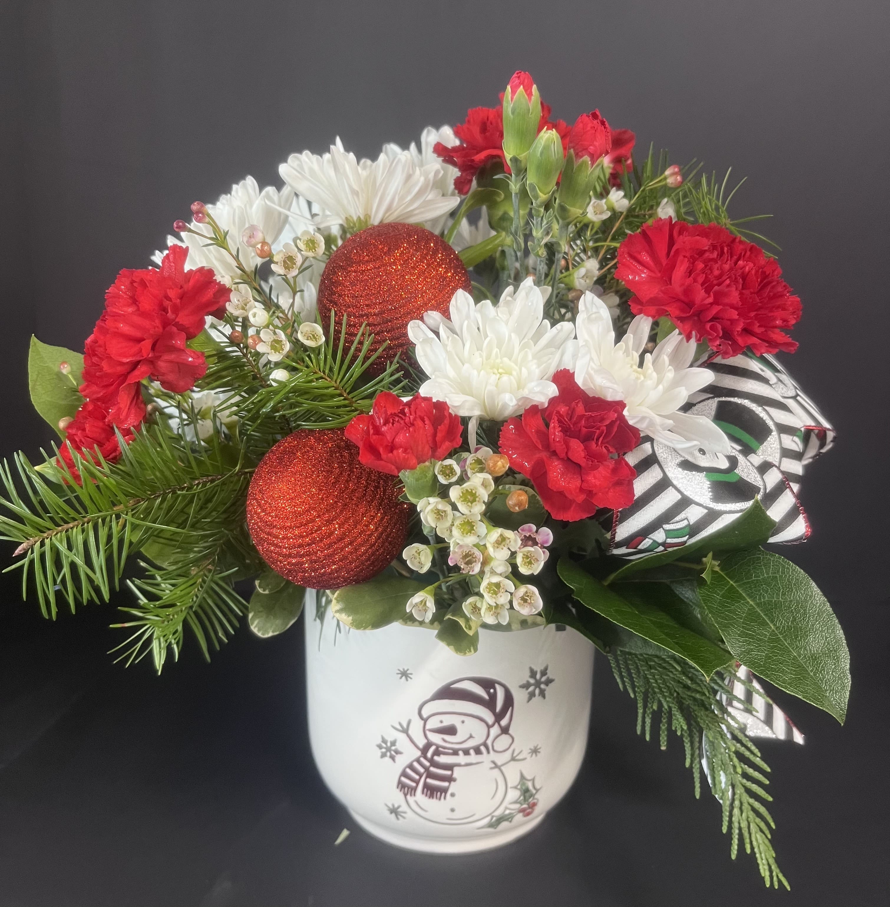 Frosty Blooms - Our Frosty boquet is designed by hand in a ceramic vase, using the freshest evergreens and bright blooms of the season.