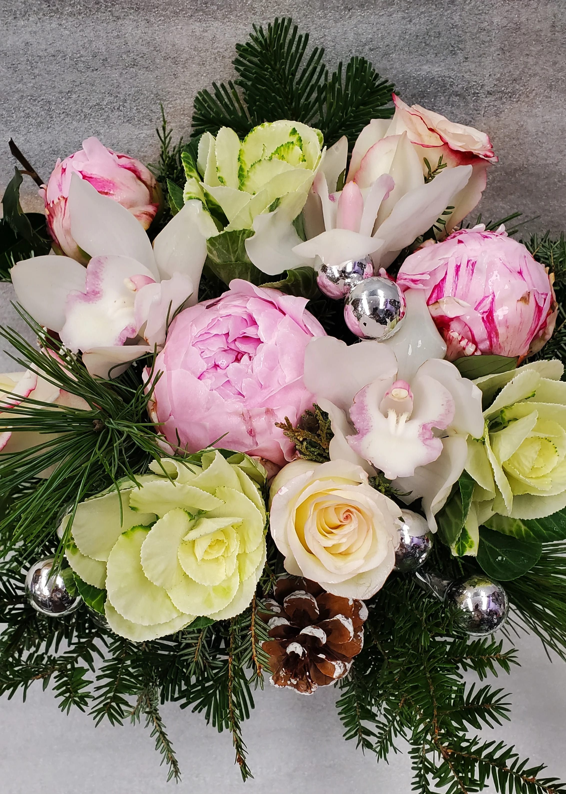 Winter in The White Mountains - Winter in the white mountains, is in a lower wooden box. this design features white cymbidium orchids, pink, peony, bi color roses, kale and assorted winter greens.