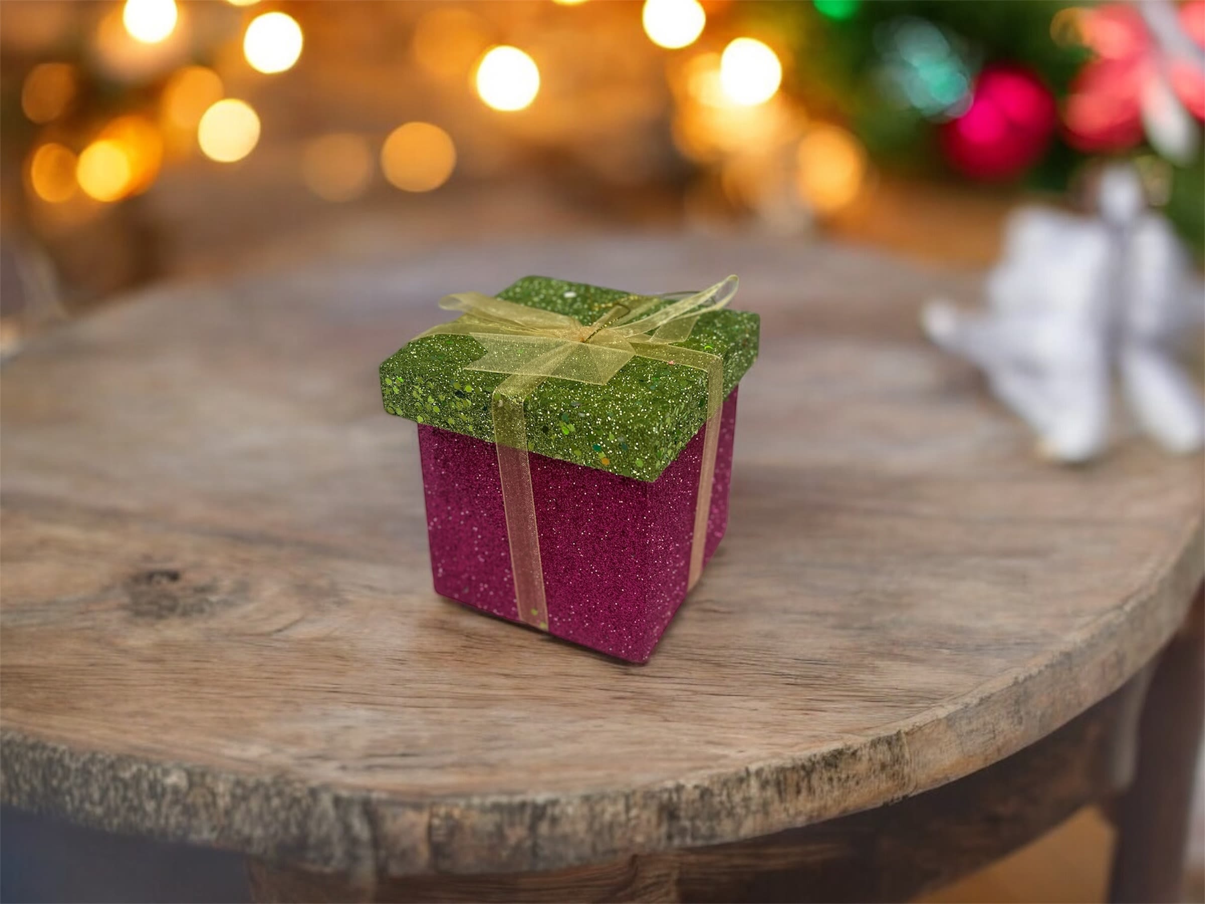 Sparkle Surprise Gift Box (Mini pink) - Add instant joy and shimmer to any occasion with this glamorous glitter gift box! Featuring a bold fuchsia body and a festive green top wrapped with a soft gold ribbon, this box is perfect for Christmas gifting, holiday treats, birthdays, Secret Santa, or packaging your floral add-ons and self-care products.  Use it as a gift box, display piece, or upgrade it with goodies for a show-stopping presentation.  Details:  Glitter exterior – bright, eye-catching + premium feel  Reusable keepsake box  Gold bow ribbon included  Perfect for gift giving, treat boxes, stocking stuffers, corporate gifts &amp; flower add-on bundles 4’4 box size