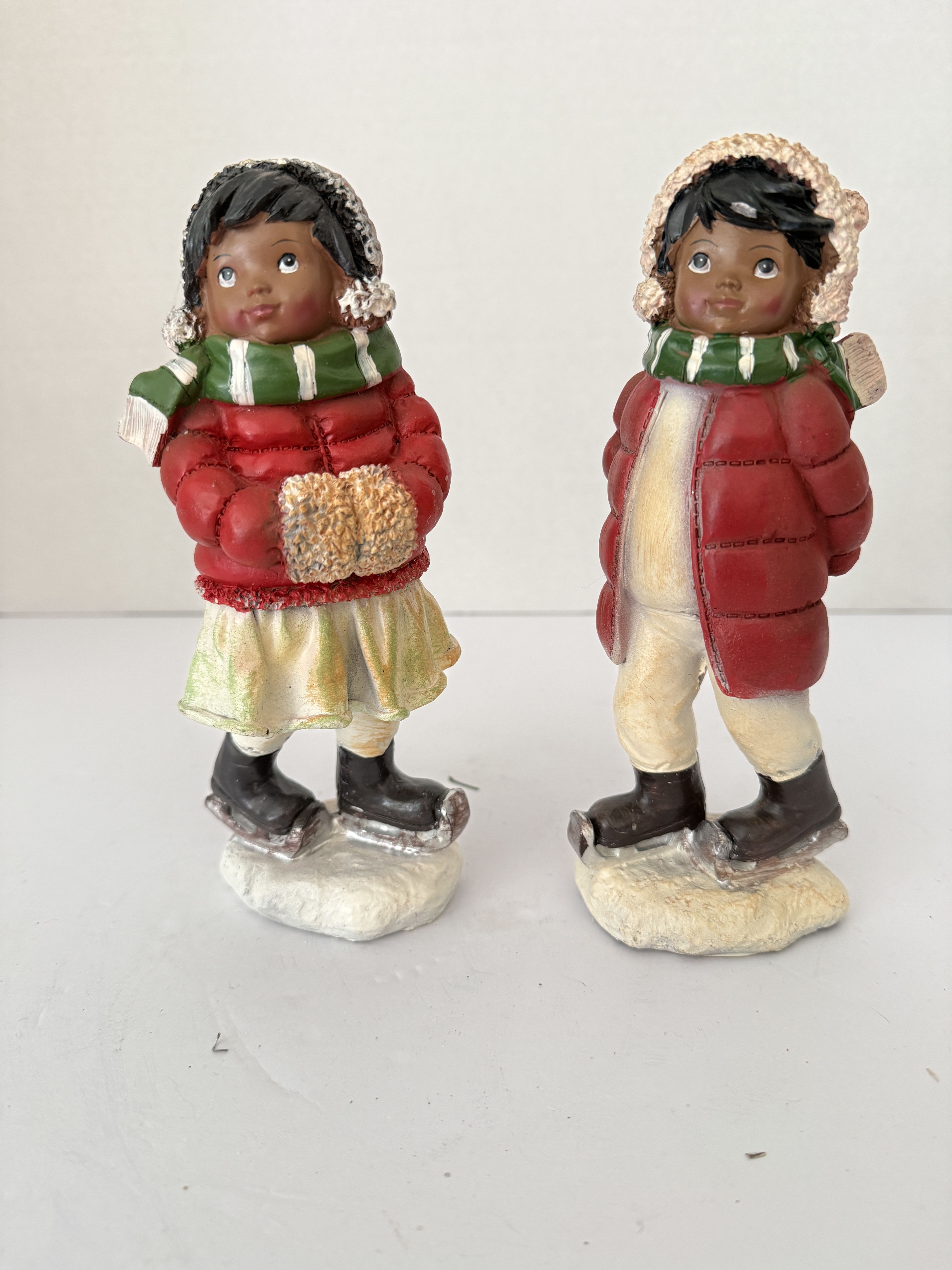 Ice stating boy and girl. - Rockwell styled Figurines of little boy and girl ice skaters.  