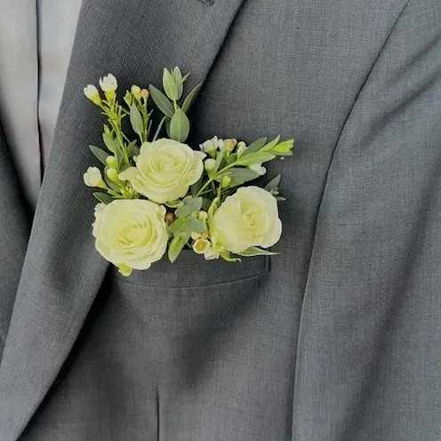 Pocket Square Boutonniere - Ditch the pins and magnets with the Stems Pocket Boutonniere!  Waterproof and fitting snug in your suit jacket pocket, spray roses, eucalyptus, and filler flower will be a great addition to your prom suit!
