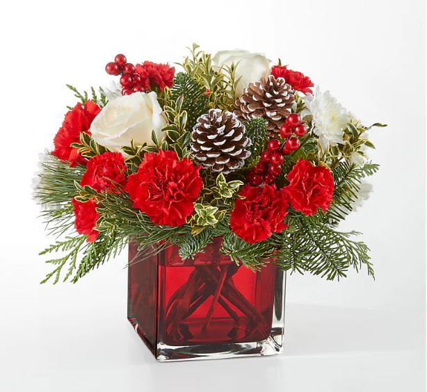 Christmas Cheer Cube - Christmas Cheer Cube Bouquet An aromatic experience, the Christmas Cheer Bouquet includes assorted seasonal greens to bring the scents of the season to you or your loved ones. Details The Deluxe Bouquet is approximately 11&quot;H x 12&quot;W. Designed by florists, ready to display. For long–lasting blooms, replace the water daily. We suggest trimming the stems every couple days.  Pet Safety Precautions: This bouquet or plant may include flowers and foliage that are known to be toxic to pets. To keep them safe, be sure to keep this arrangement out of your pet's reach.  Bloom Details- Carnation, Christmas Greens, Rose