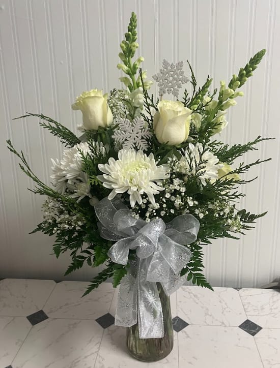 Falling Snow - Capture the peaceful beauty of a snowfall with our Falling Snow Vase. This elegant all-white arrangement is accented with snowflake picks and finished with a coordinating snowflake bow. A serene and wintry design ideal for holiday décor or sending seasonal wishes.