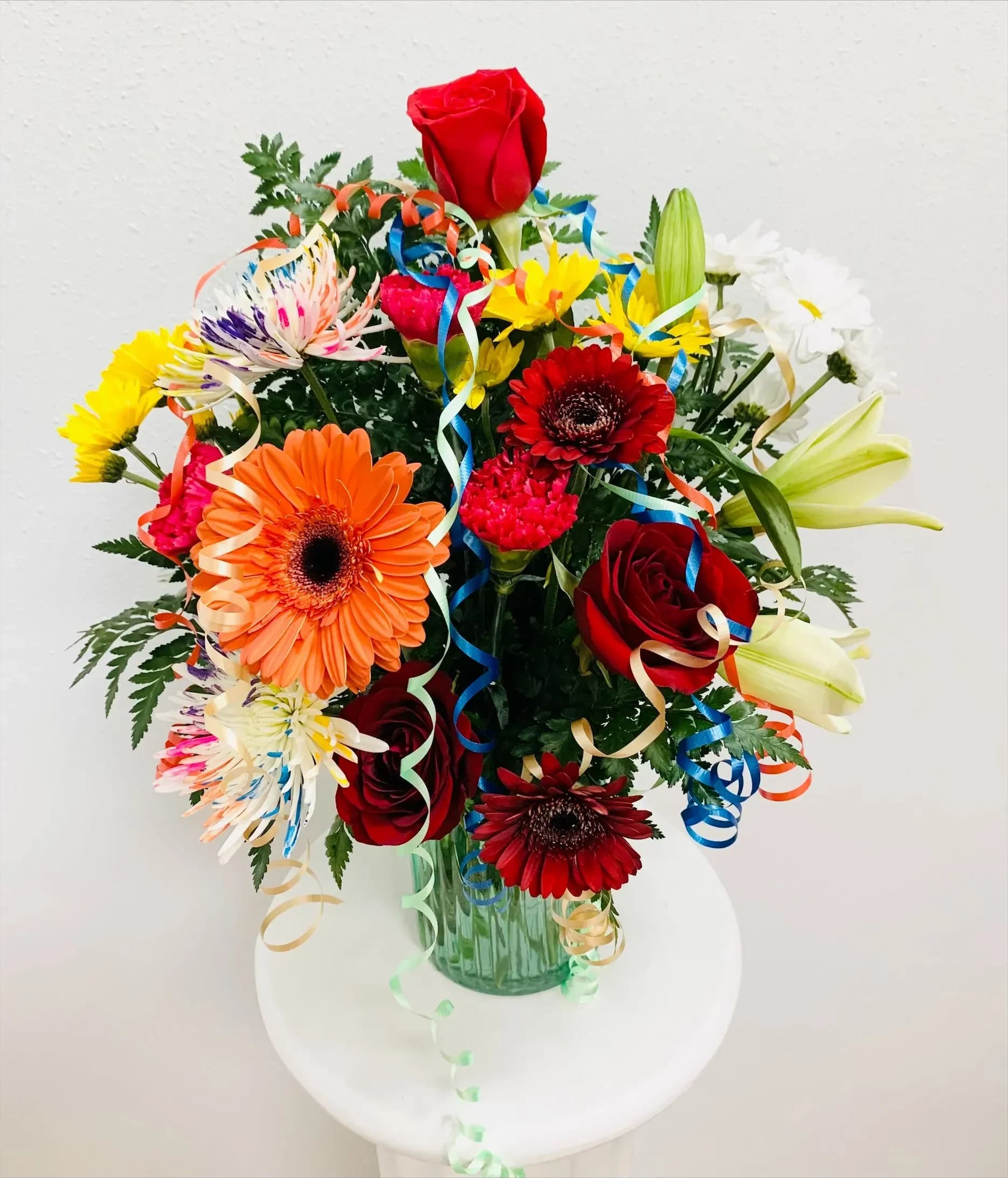 Stems and Streamers - Roses, Daisy mums, Asiatic lilies, carnations, and Gerbera daisies all decked out with streamers and your best wishes!