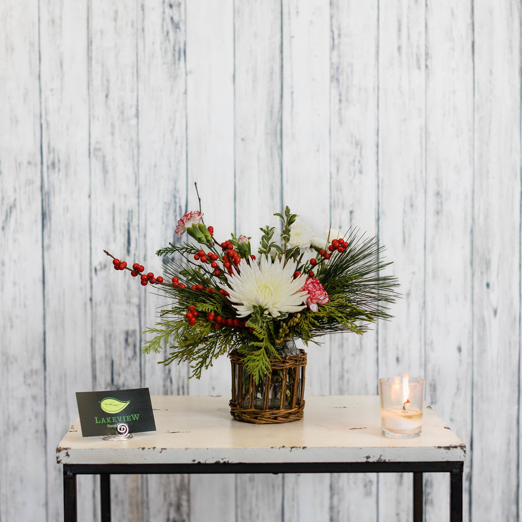 Jovial  - Perfect for a end table or desk, this petite holiday arrangement features red winterberry, peppermint mini carnations and a white spider mum.   Approximate Dimensions: 11&quot;H x 11&quot;W