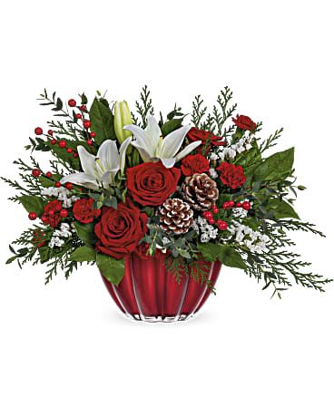 Winter Radiance Holiday Bouquet - Bring the elegance of the season into your home with our Winter Radiance Holiday Bouquet, a luxurious Christmas arrangement designed to capture the beauty and warmth of winter celebrations. This stunning bouquet features fragrant white lilies, premium red roses, and vibrant red mini carnations, perfectly paired with frosted pinecones, red berries, and lush seasonal evergreens for a festive, sophisticated look.  Presented in a rich red glass bowl vase with a radiant finish, this arrangement adds a touch of holiday glamour to any space. The bright whites, deep reds, and natural greenery create a striking contrast that instantly enhances dining tables, entryways, offices, or holiday gatherings.  Handcrafted with precision by Miami Flowers Design, this bouquet is ideal for customers looking for luxury Christmas flowers, holiday gifts, or same-day Christmas delivery in Miami. Its elegant style and premium blooms make it a perfect choice for spreading joy, celebrating the season, or gifting someone special.  The Winter Radiance Holiday Bouquet is a timeless expression of Christmas beauty—classic, fresh, and unforgettable.