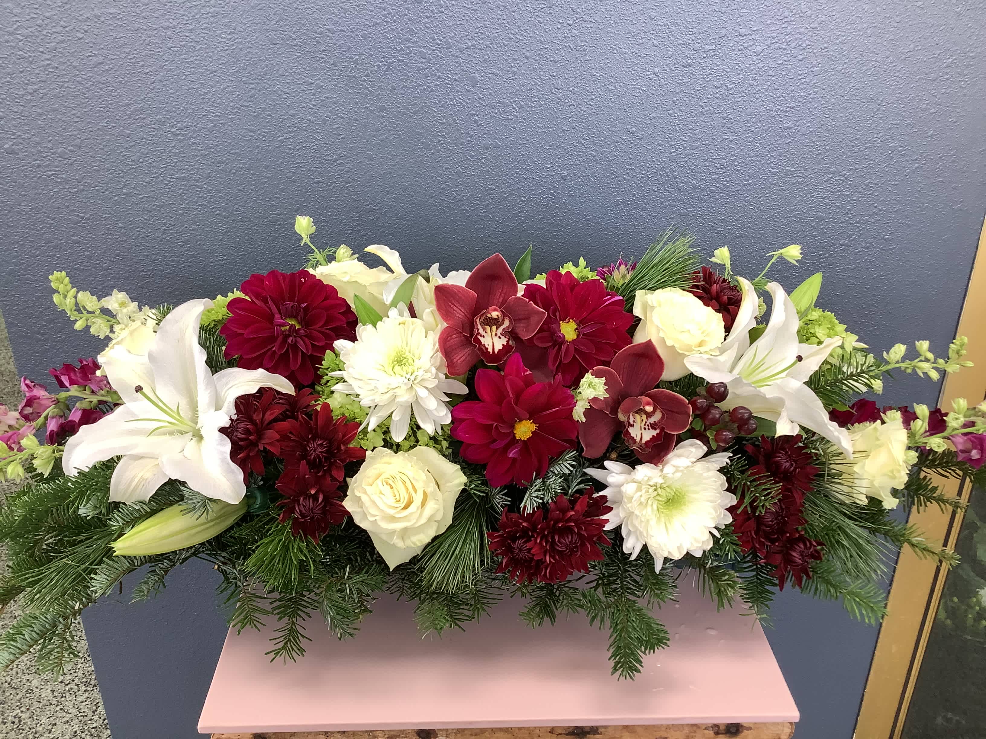 Premium Christmas Centerpiece  - Beautiful combination of Christmas greens and premium flowers such as dahlias, cymbidium orchid blooms, roses, lilies and many more.