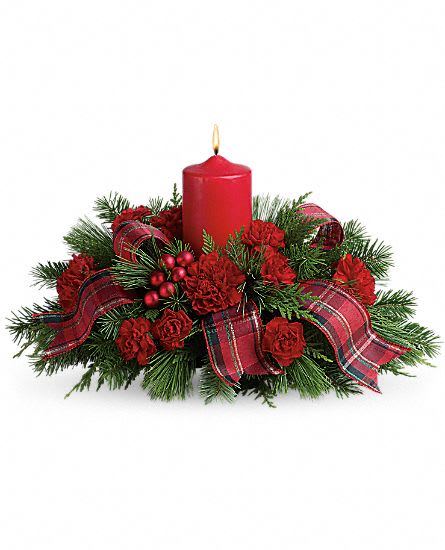  Family Celebration  - Don't show up to Christmas dinner empty handed! Charm your hostess, family and friends with this casual Christmas dinner centerpiece that's holiday flowers, a candle and a gift all in one.