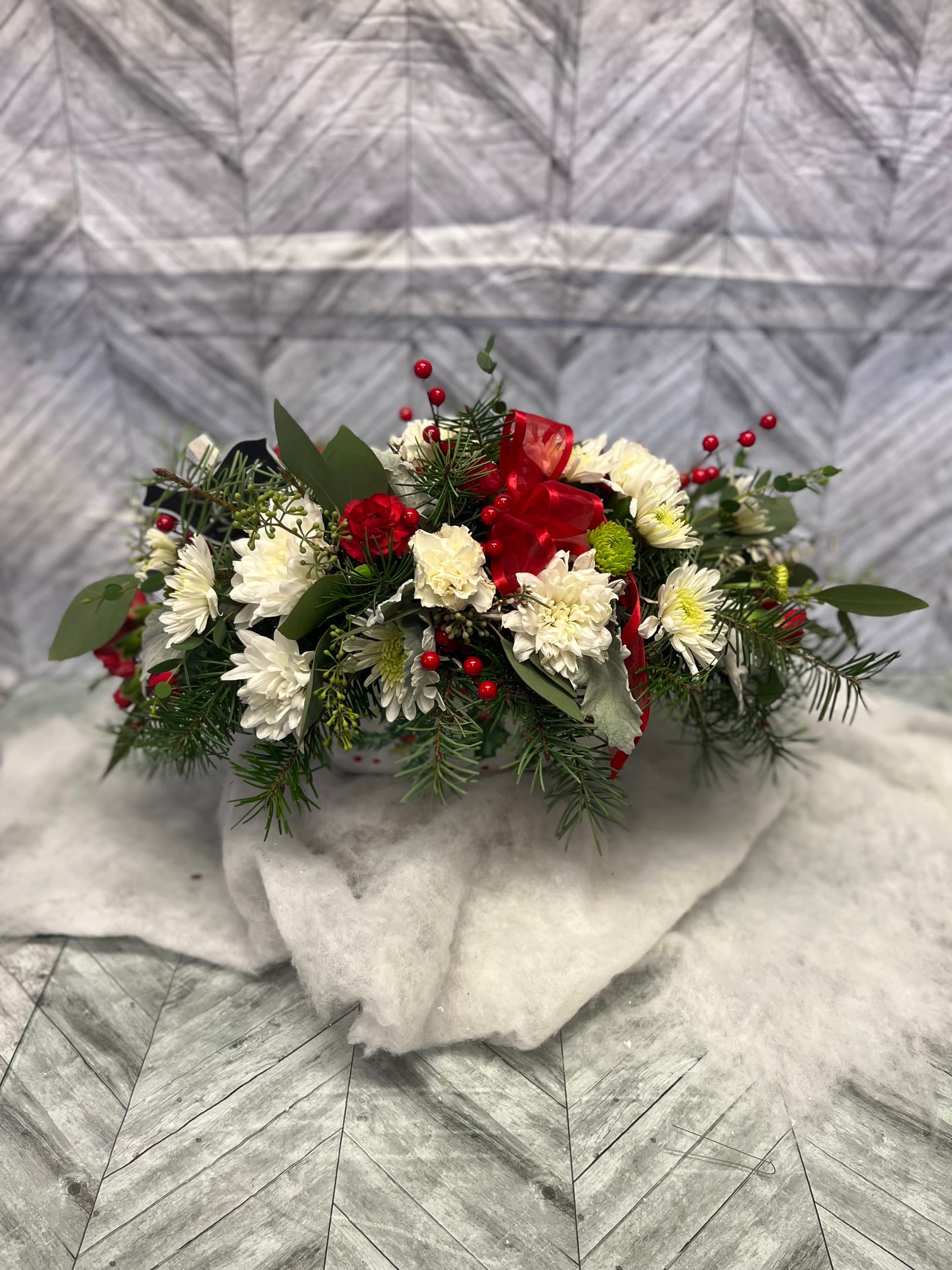 Fa la la la la Centerpiece - Christmas greens, cushion mums, white carnations, red mini carnations and red berries in centerpiece tray