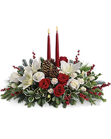 Christmas Wishes Centerpiece  - Your wishes for a classic Christmas centerpiece have come true! This elegant arrangement features two glowing red taper candles atop a bed of noble fir, white pine and luxurious roses.