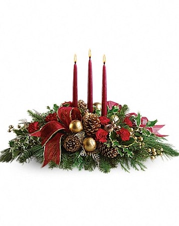 All is Bright Holiday Centerpiece - All will be bright this season when you order this joyful Christmas arrangement. A lovely centerpiece, it will light up the holiday festivities beautifully.  Miniature carnations are artfully on display with merry touches like shimmery ornaments, pinecones, berries, organza ribbon and holiday greens. Three graceful red taper candles add the perfect magical touch. Approximately 23&quot; W x 16&quot; H  