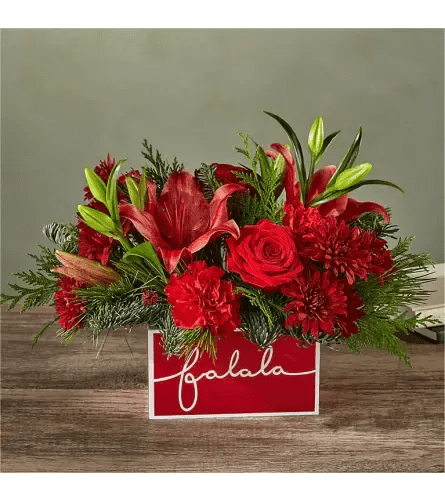 fa la la  - Deck their halls with this lively bouquet studded with surprising red lilies and a jolly keepsake box that captures the joy of the season. Please Note: The bouquet pictured reflects our original design for this product