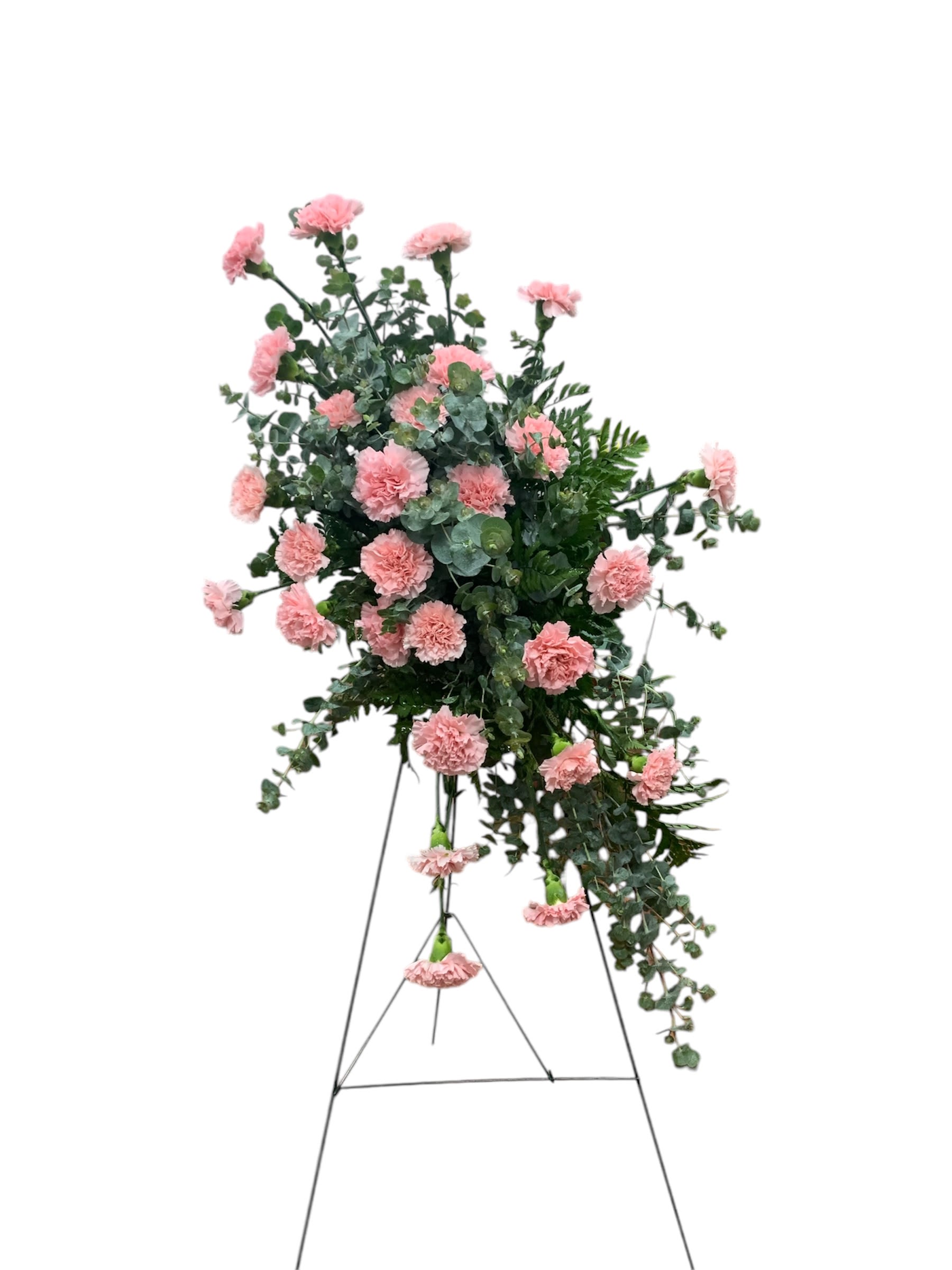 Memorial Spray - An asymmetrical carnation spray and foliage sit on an easel to provide the perfect addition to a loved one’s service.