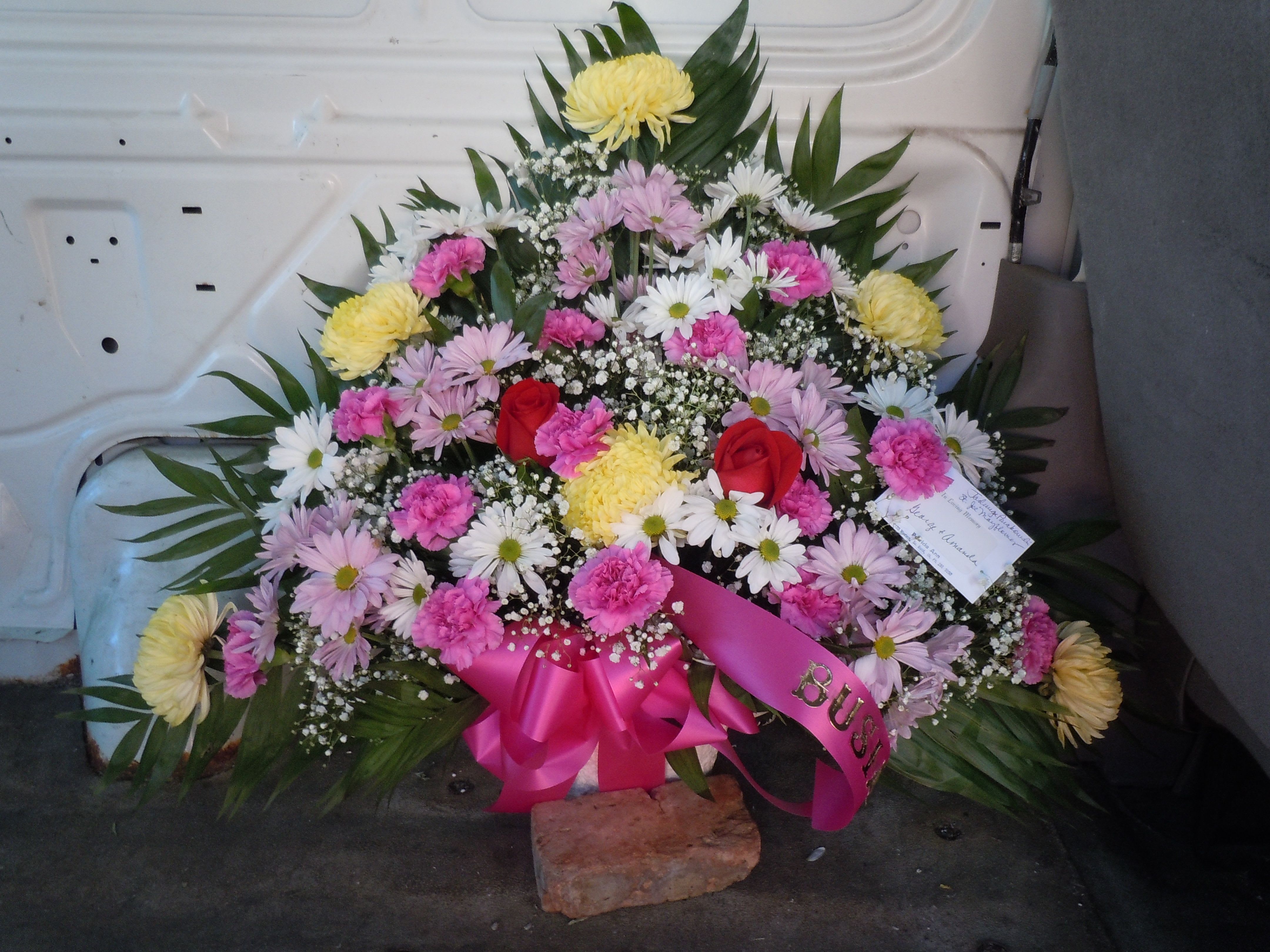 TB14 Traditional Basket - Sympathy mache - includes yellow spider mums, white and lavender daisies, ferida carnations, baby's breath, greens, and bow.-no roses  Banners not included $15 + per banner    Substitutions may apply pending flower availibilty