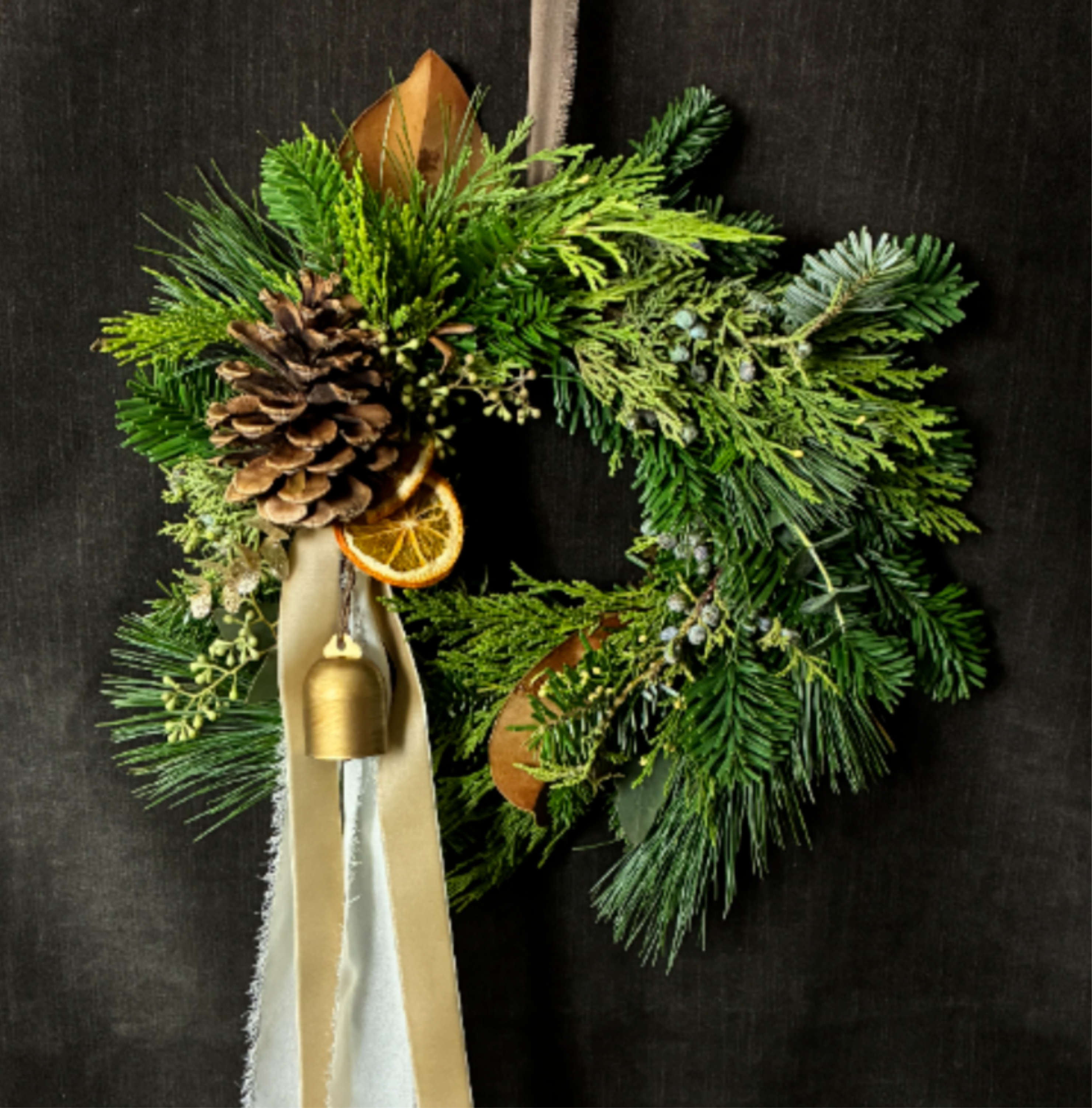Ivory &amp; Ember Wreath 10" - The Ivory &amp; Ember Wreath features burnt sienna tones, soft ivory ribbon, and a warm gold bell accent. Measuring approximately 10” with a long trailing ribbon, it brings a cozy, hearth-inspired glow to any space.