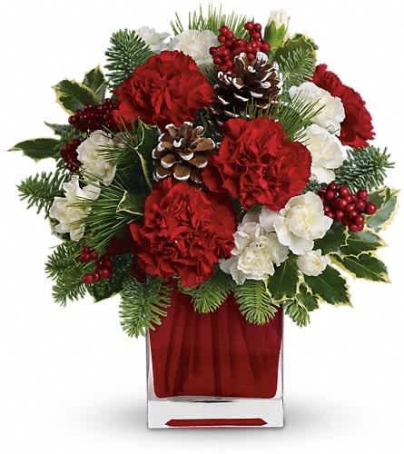 Make Merry by Flower Sensation - Deliver a winter's day delight. This sweet bouquet includes red carnations and white carnations beautifully arranged in our bright red glass cube. Red carnations and white miniature carnations are accented with tips of noble fir white pine holly and assorted greens. Delivered in Teleflora's bright red glass cube.Approximately 11 1/2" W x 12 1/2" H Orientation: One-Sided As Shown : TWR04-1ADeluxe : TWR04-1BPremium : TWR04-1C