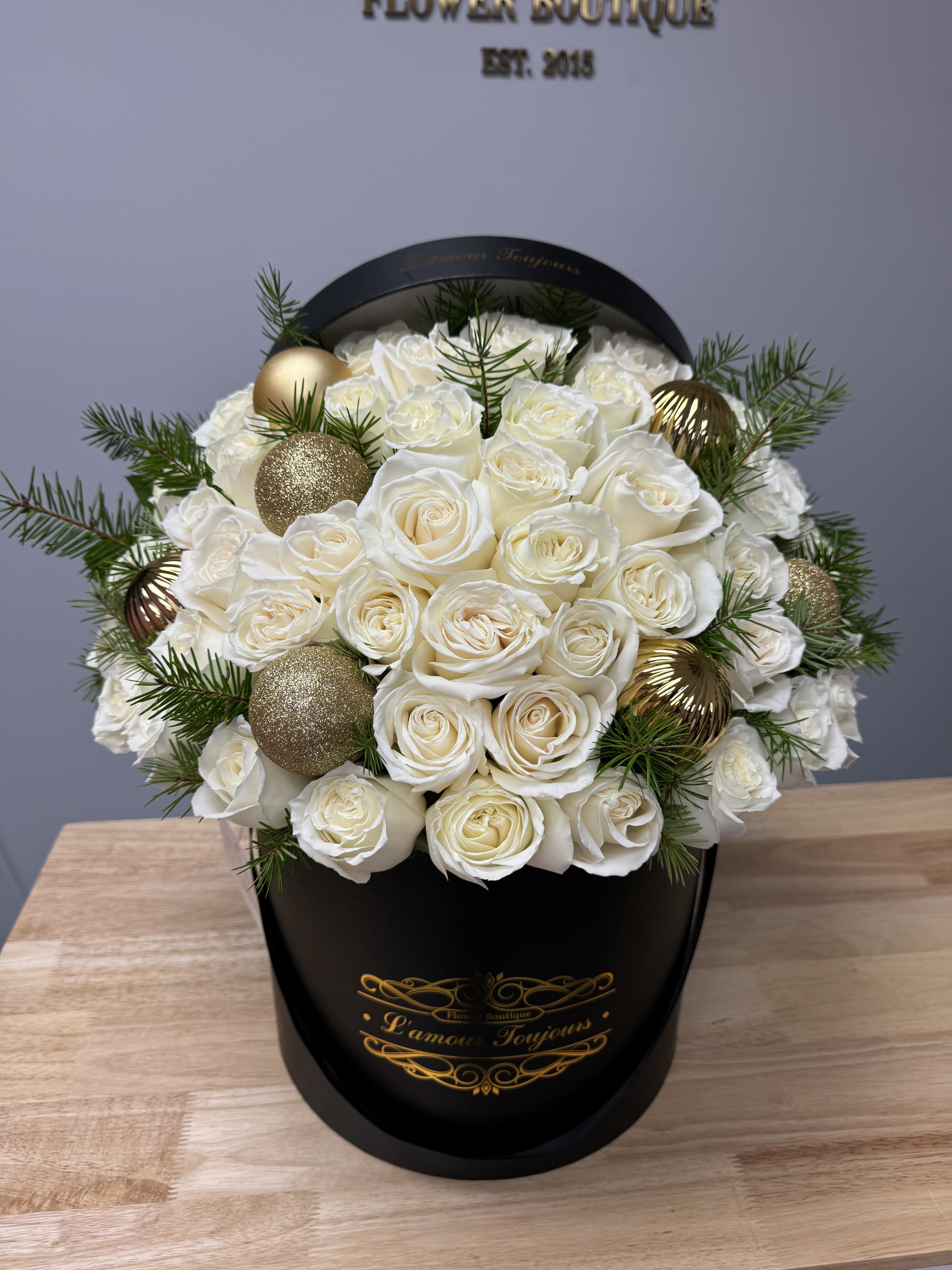 Happy Holidays flower box - 50 white roses with ornaments and pine in our Signature box