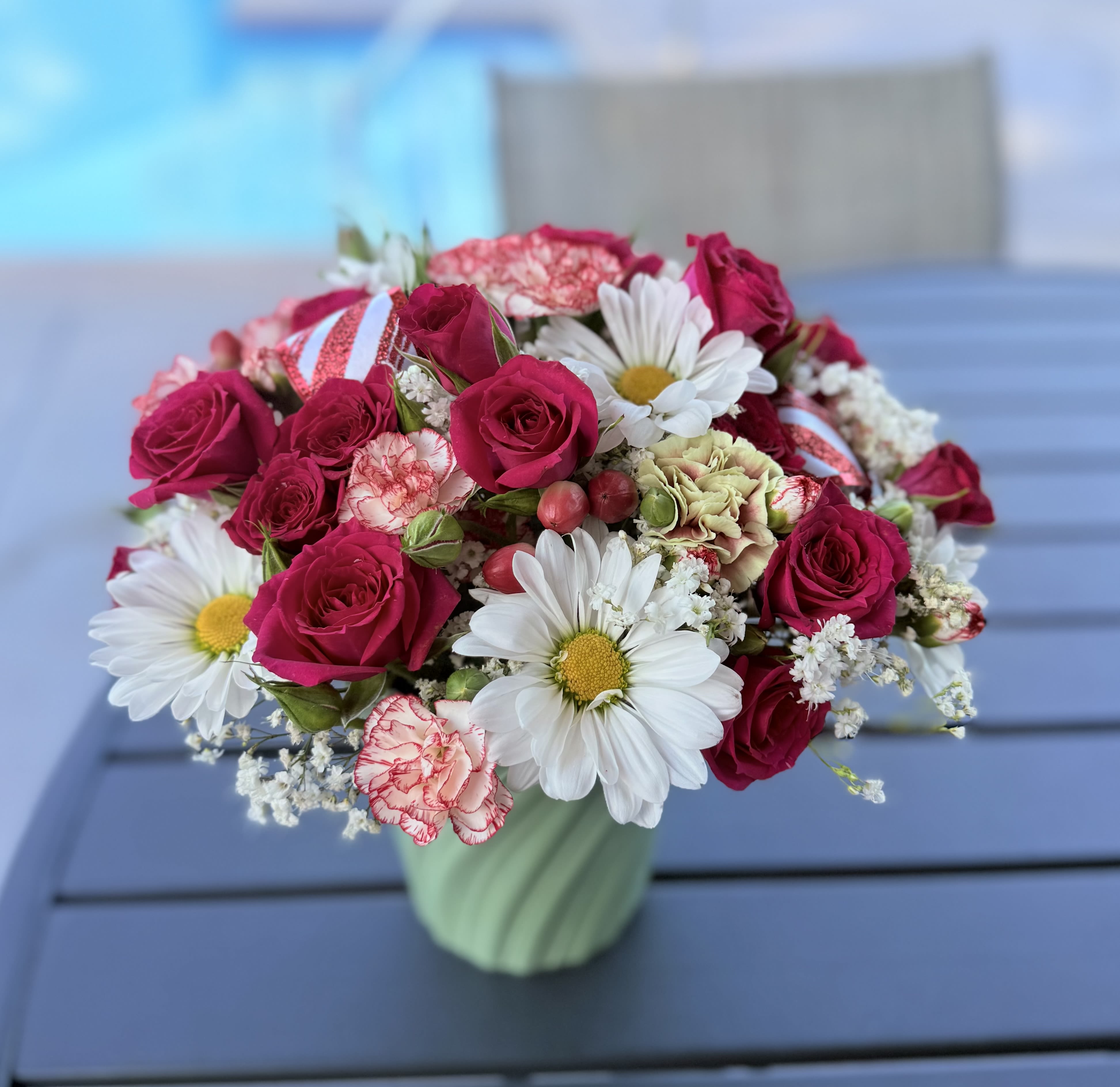 “Le Fleur  “ Classic Floral Centerpiece  - Inspired in the classic designs of France, this beautiful centerpiece evokes happy moments to celebrate.  It’s designed with premium roses, fancy carnations, ruby hypericums, blooming daisies and white filler flowers Medium size 11”x 11” Classic style 