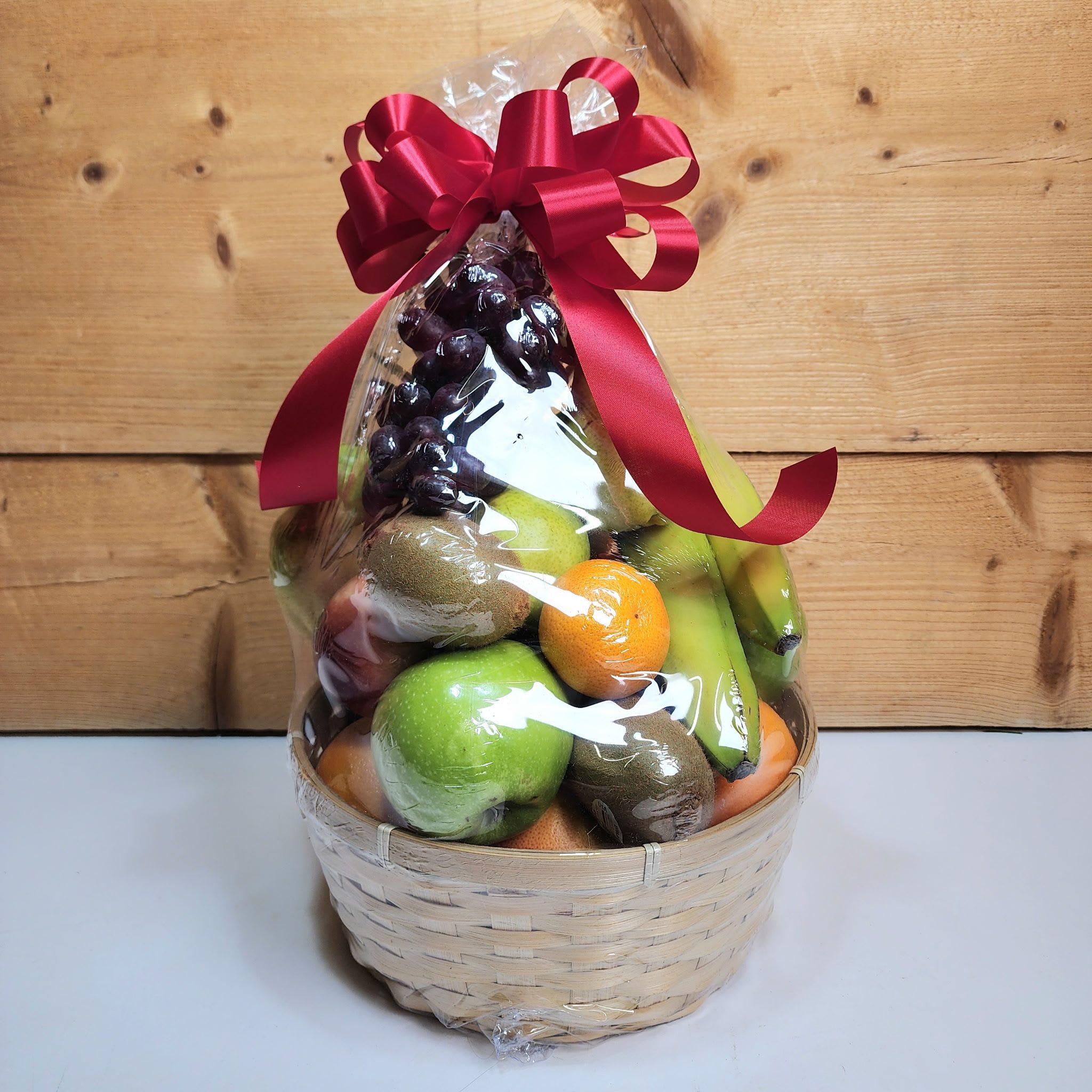 Fruit Basket - No matter the occasion, our fruit baskets make the perfect gift! With three different sizes available to fit your gifting needs, we've got you covered with an amazing way to show that you're thinking of them.  Standard Fruit Basket - approx. 18 pieces of fruit Deluxe Fruit Basket - approx. 25 pieces of fruit Premium Fruit Basket - approx. 25 pieces of fruit, including bunches of berries  Whether you're sending a housewarming gift, a thank you, or a thinking-of-you, our fruit basket say it all in a meaningful (and delicious!) way.  NOTE: Same-day Orders are not available to ensure that we acquire and deliver only the freshest of fruit