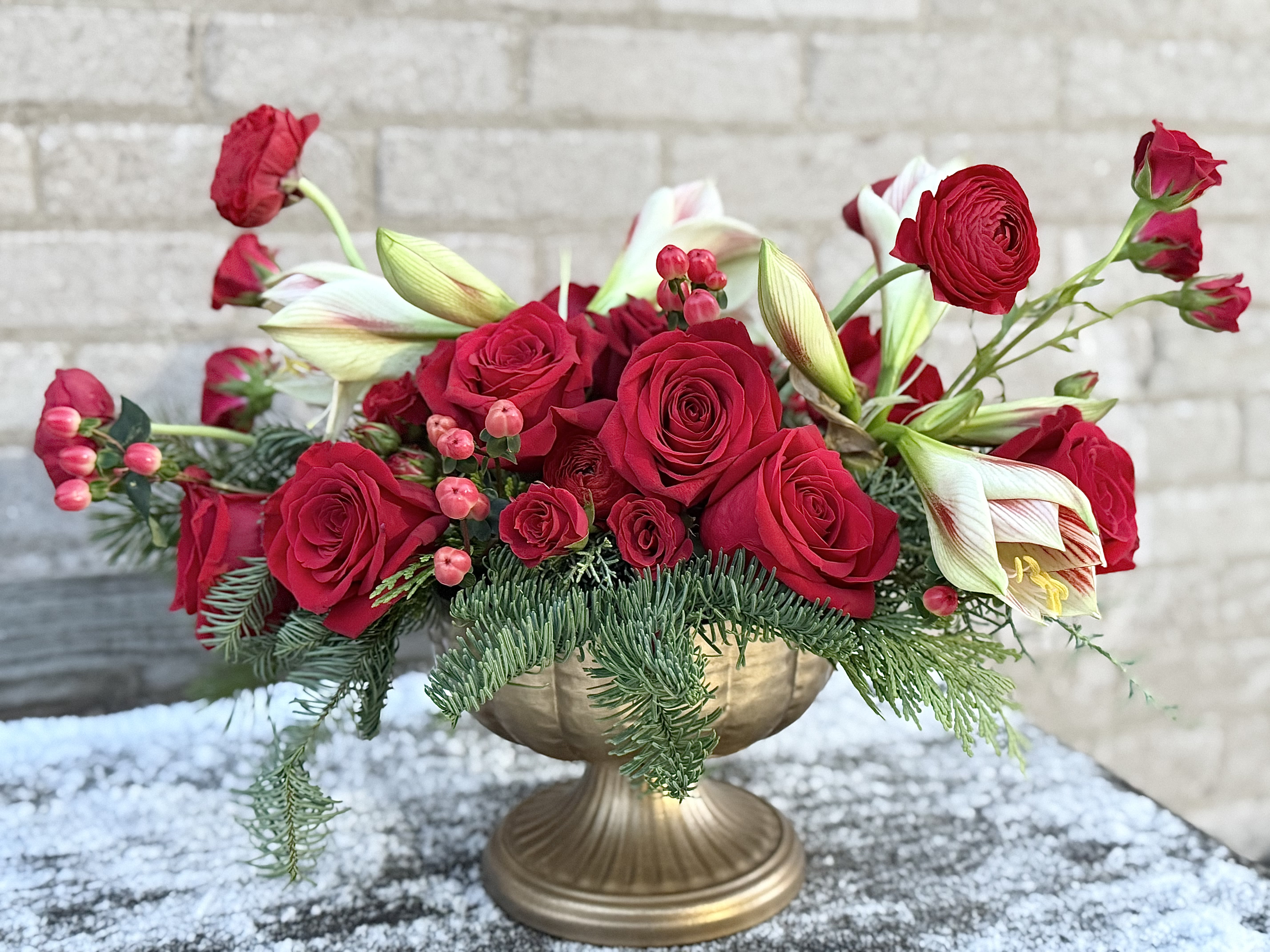 Classic Christmas Centerpiece - A carefully designed centerpiece for a very special, traditional and warm table during your special Christmas celebration. We have used winter greens and speciality blooms