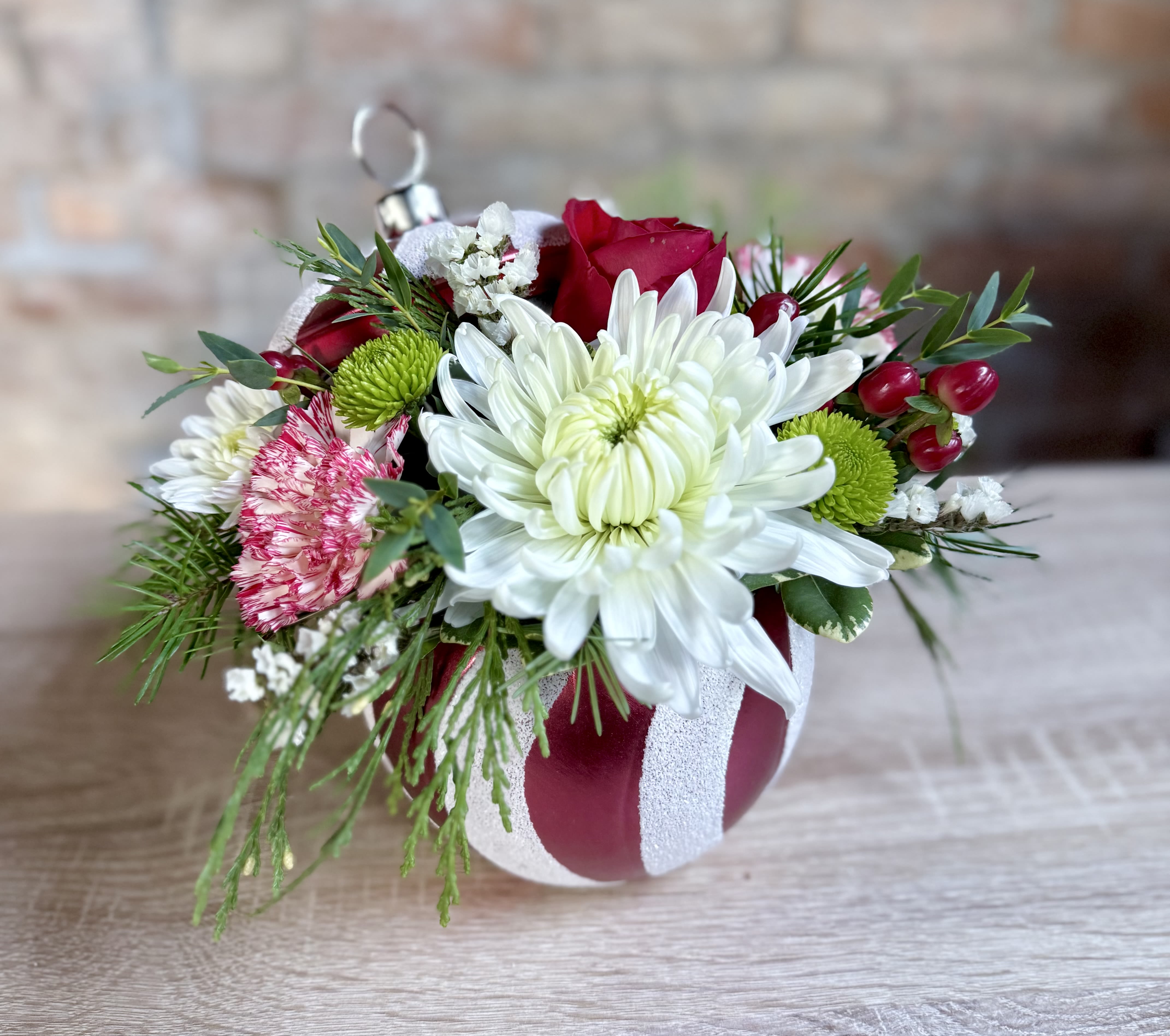 Holiday Ornament Arrangement  - A cute ornament container with all red and white flowers and winter greens. 