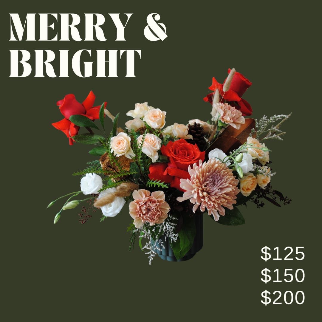 Merry &amp; Bright- Red, peach, and white holiday arrangement - Merry &amp; Bright is a modern arrangement artfully designed in ceramic pot using red, peach, and white toned florals, and winter accents and greens!!  *Image shown is valued at $125 *The $150 and $200 price points will be made with more flowers to match the value using blooms in the same color palette *Due to holiday demand and supplier availability, substitutions will be made to acheive a look as similar as possible to the photo