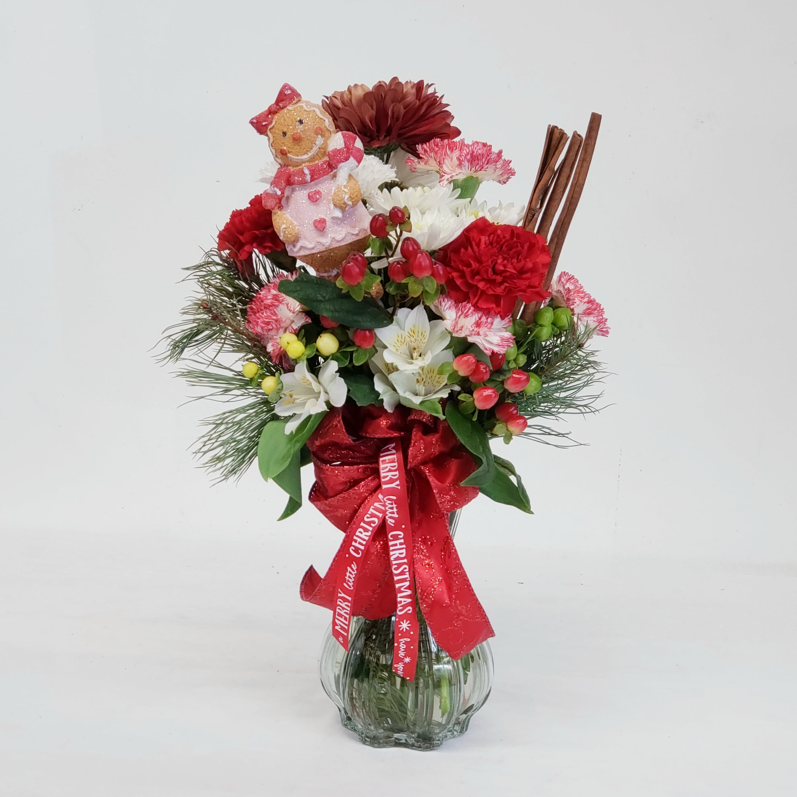 Cinnamon Swirl - A merry mix of fresh Christmas blooms complimented by aromatic sticks of cinnamon and a gingerbread ornament. Have this cheerful bouquet delivered today to those special people on your nice list! Approx 20" to 24" tall. Ribbon color and style varies. 
